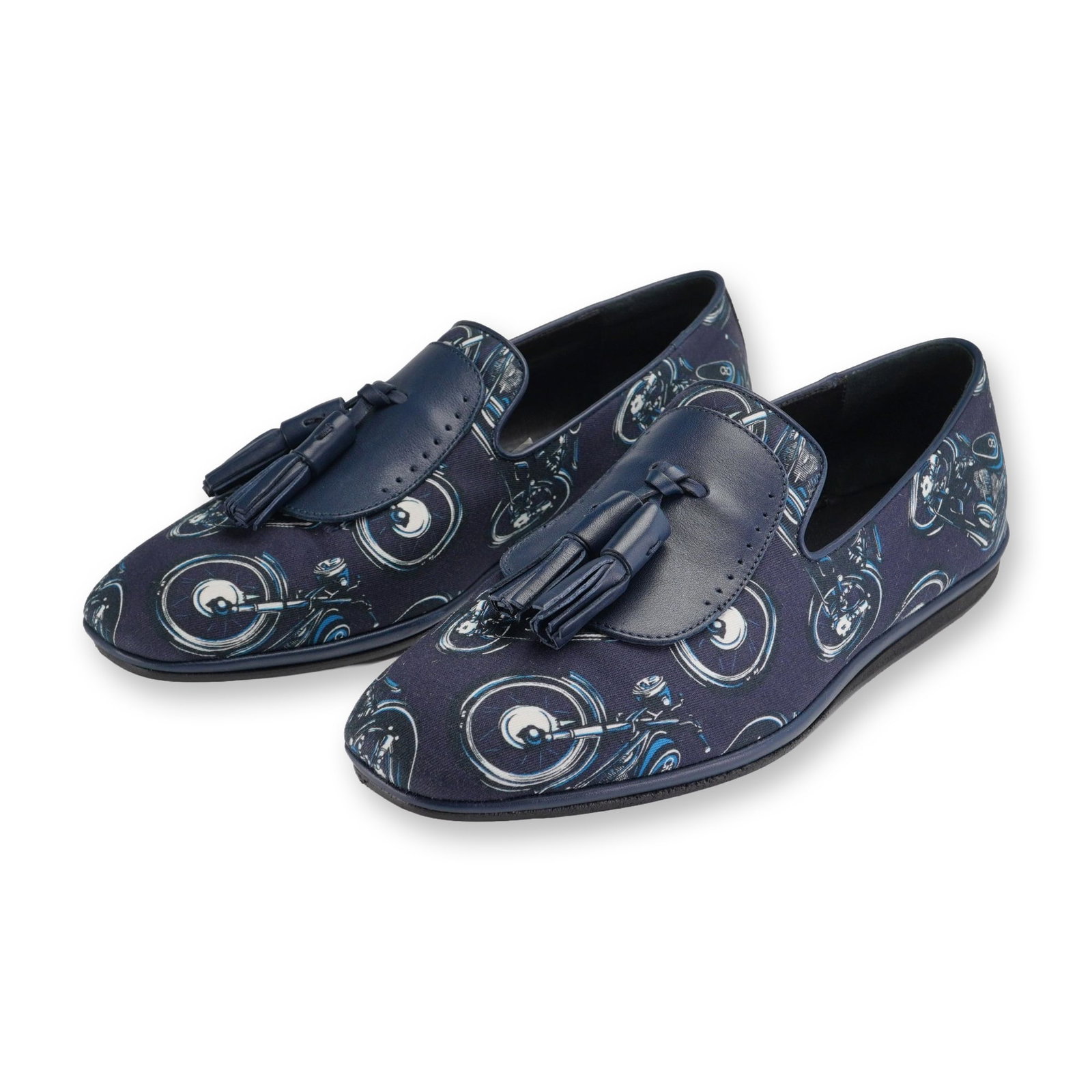 Salvatore Ferragamo Finnegan Blue Motorcycle Print Loafers: Salvatore Ferragamo Finnegan slip-on tassel loafers in dark blue fabric with an all-over motorcycle graphic print. Features a navy blue leather saddle trim, matching leather tassels, leather piping, a