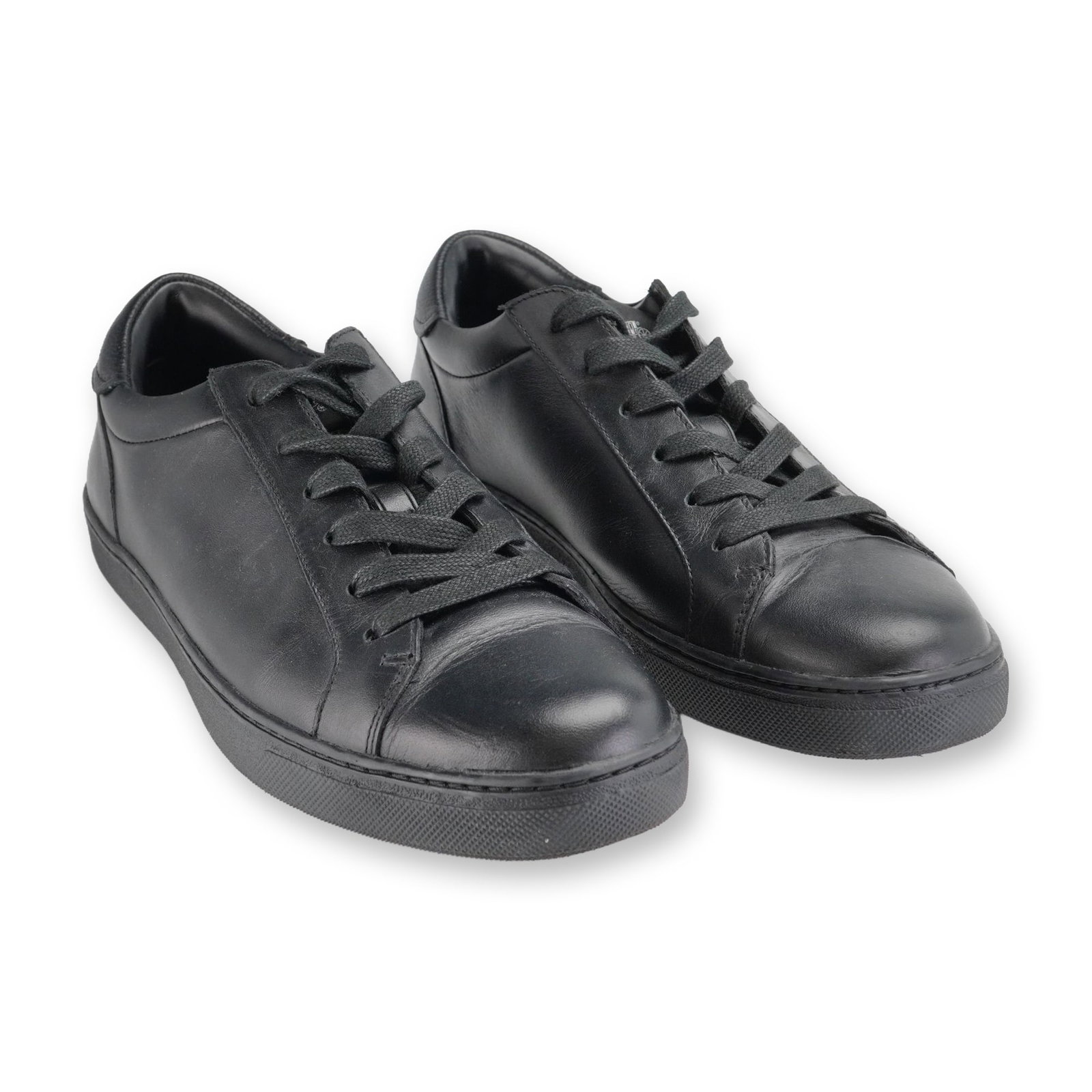 Pair of Coach Mens Black Leather Sneakers: Pair of Coach mens FG1947 low-top lace-up sneakers in black smooth leather, featuring pebbled leather heel accents and tonal rubber outsoles. The insoles are printed with Coach branding, and the heel 