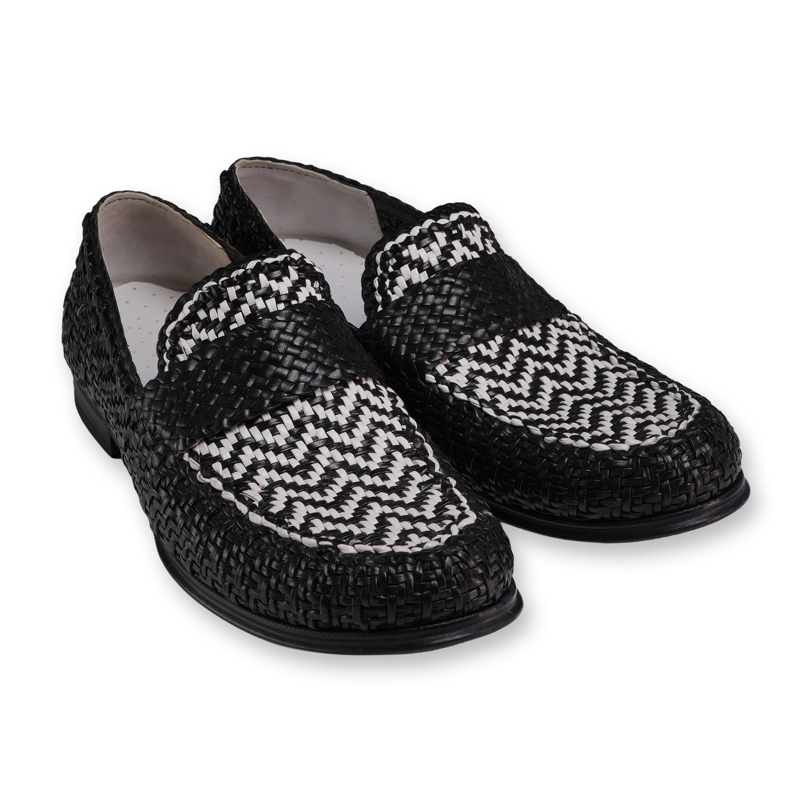 Pair of Dolce & Gabbana Italian Black and White Woven Leather Loafers: Dolce & Gabbana Italian made men's slip-on loafers in woven leather. The design features a solid black interwoven body with a contrasting black and white geometric pattern on the apron and saddle stra