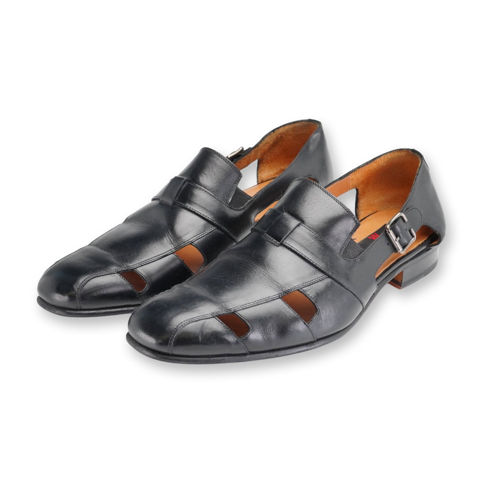 Pair of Mezlan Handel Leather Dress Sandals: Pair of Mezlan Handel black leather dress sandals featuring a closed-toe and closed-back design with cut-out side panels. Styled with a single monk strap secured by a polished silver-tone buckle closu