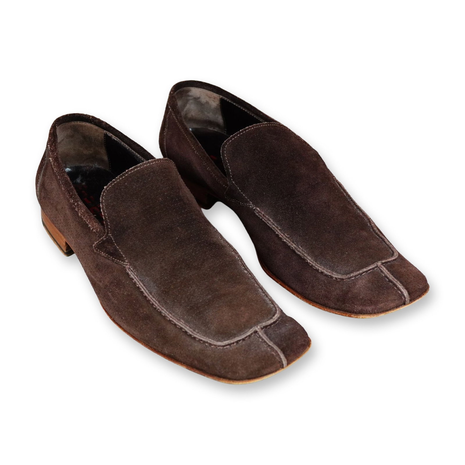 Pair of Miu Miu Suede Square Toe Loafers: A pair of Italian square-toe slip-on loafers in dark brown suede by Miu Miu. The design features a stitched apron with a central vertical toe seam, low heels, leather lining, and leather soles. The in