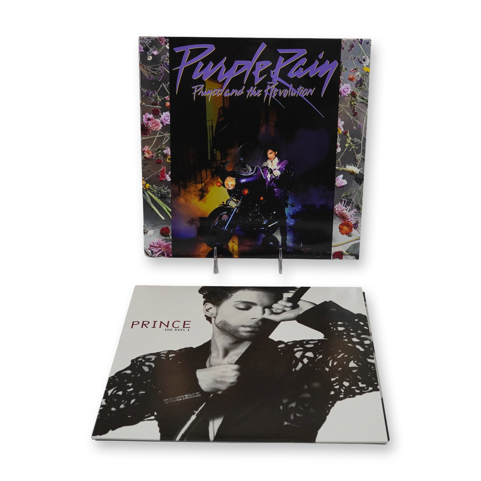 Two Prince Purple Rain and The Hits 1 LP Vinyl Record Albums: Two Prince vinyl record albums featuring Purple Rain and The Hits 1. Purple Rain by Prince and the Revolution is a 12 inch vinyl LP on Warner Bros. Records, originally released in 1984. The jacket fea