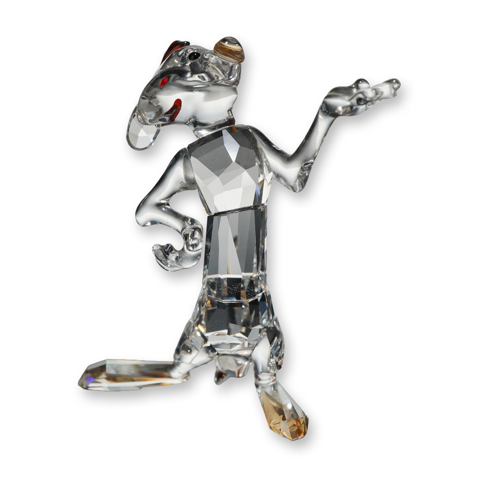 Swarovski Crystal Disney Timon Meerkat Figurine: Swarovski. Disney crystal figurine depicting the meerkat character Timon from the animated film The Lion King. The figure is composed of faceted clear crystal with amber-toned crystal accents on the f