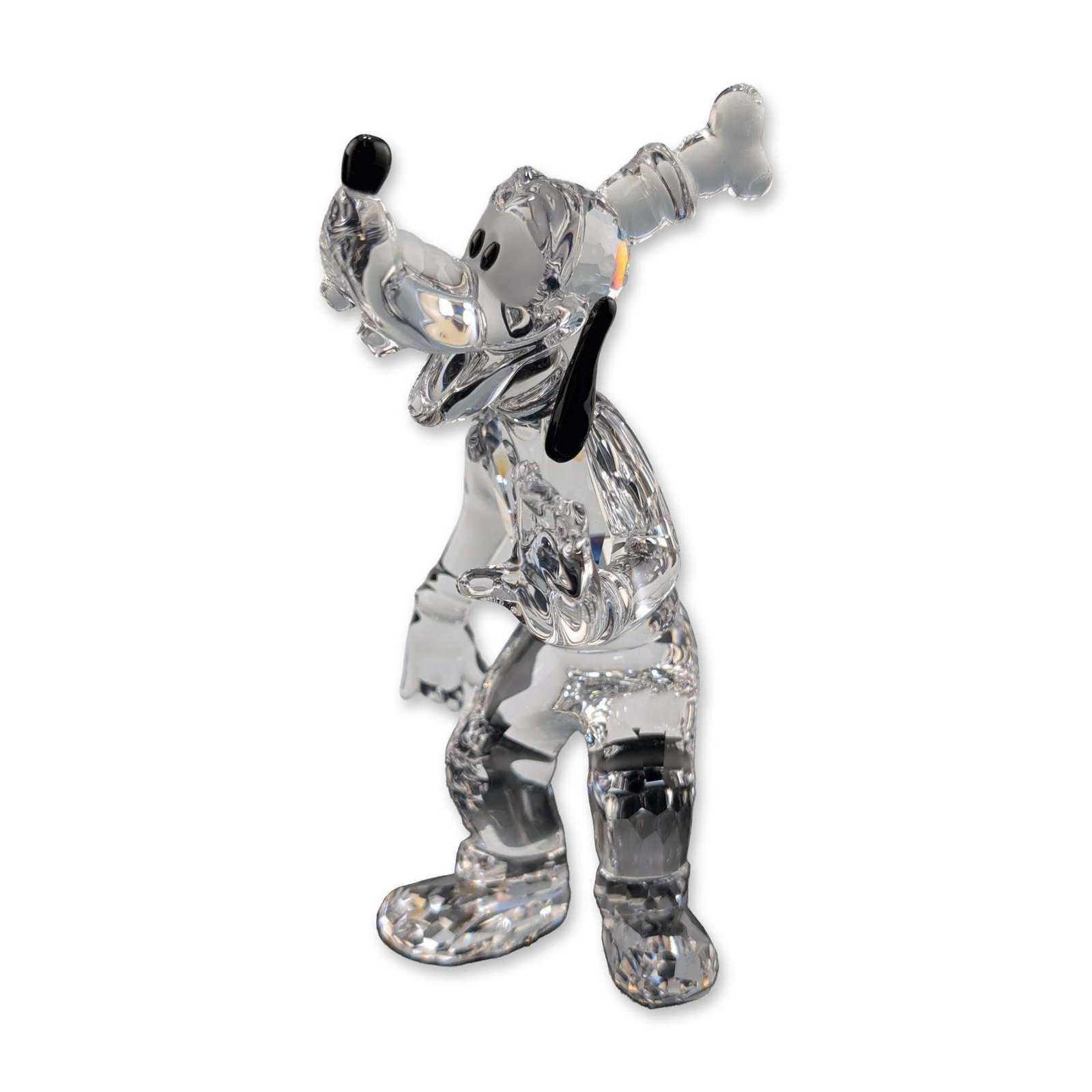 Swarovski Disney Showcase Collection Crystal Figurine, Goofy: Swarovski Disney collection Goofy figurine in faceted clear and black lead crystal. The figure is depicted in a dynamic leaning pose with a raised arm and features black crystal accents for the eyes, 