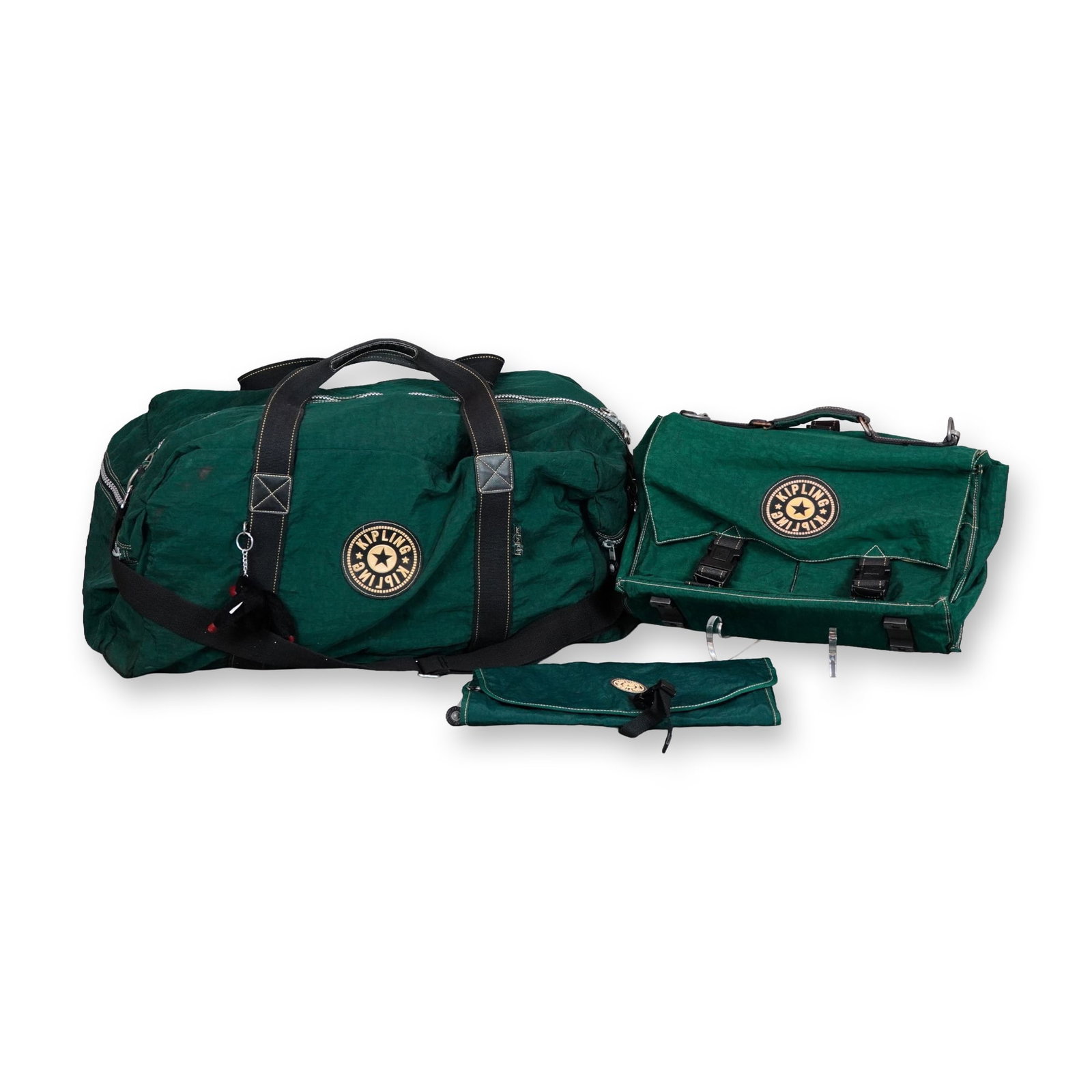 2pc Kipling Forest Green Nylon Duffle and Messenger Bag Set: A set of two Kipling travel bags in forest green crinkle nylon, accompanied by an internal hanging cosmetics bag organizer. The set includes a large barrel-style duffle bag and a structured flap messe
