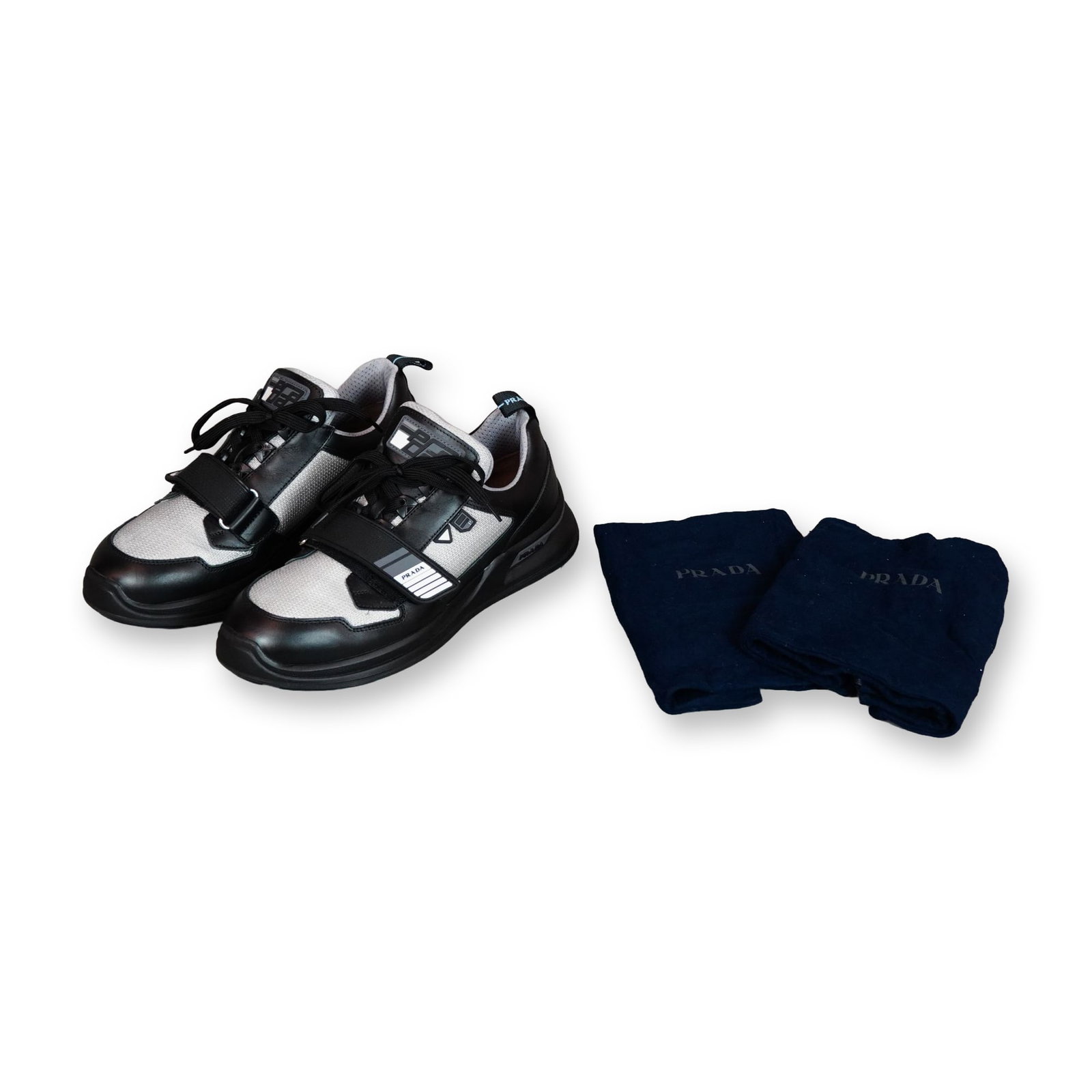 Prada Mechano Black and Silver Leather Mesh Sneakers Size 8: Prada (Italy) Mechano low-top sneakers, style number 2EG266, featuring a mixed-media design with smooth black leather panels and metallic silver-toned mesh inserts. The uppers are styled with a front 