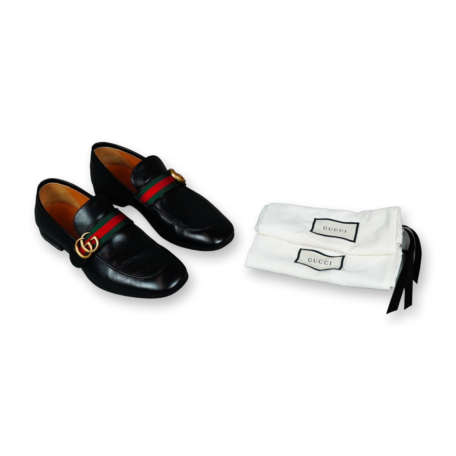 A Pair of Gucci Donnie Web Leather Loafers: A pair of Gucci Donnie Web loafers in black smooth leather, featuring the signature green and red fabric Web stripe and an antique gold-toned metal double G logo. Stamped 428609 on the interior lining