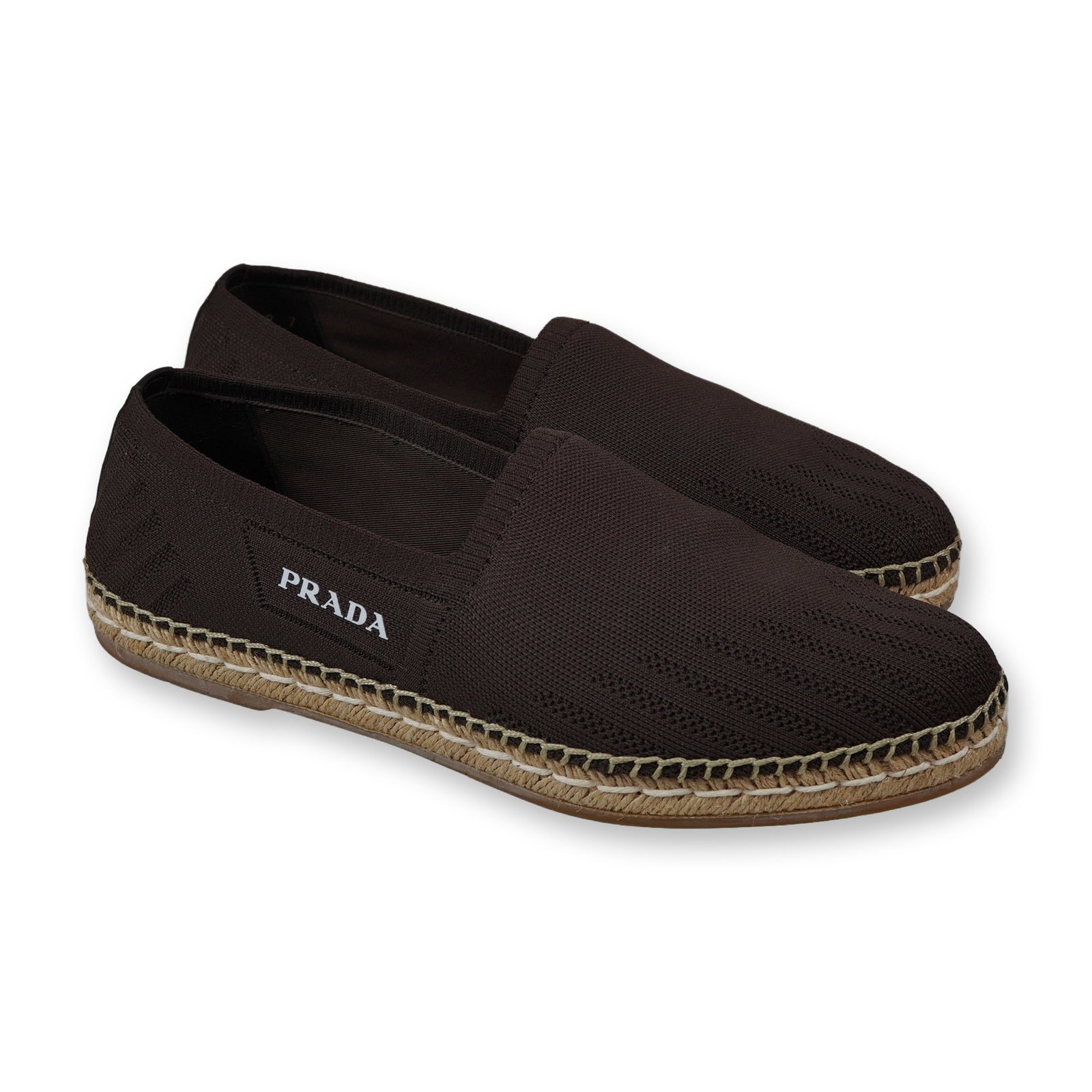 Pair of Prada Men's Brown Canvas Espadrille Loafers: Prada. Men's slim slip-on espadrille loafers, model 2DE118, featuring dark brown canvas uppers with a technical knit texture. The design includes a classic woven jute midsole and tan gum rubber outsol