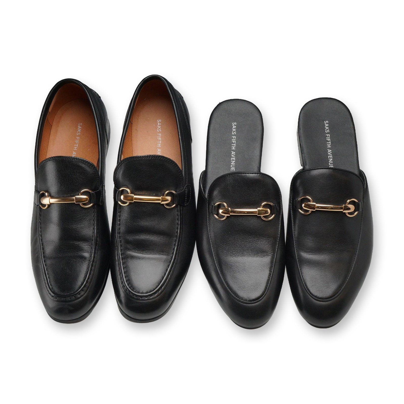 Two Pairs Saks Fifth Avenue Mens Leather Loafers: Two pairs of Saks Fifth Avenue men's black leather horsebit loafers, including the Firenze closed-back style and the Redford backless mule style. Both pairs are constructed from black leather with lea