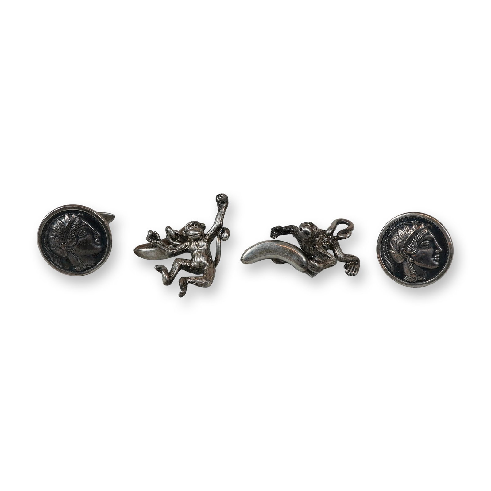 4pc Sterling Silver Monkey Figural and Coin-Style Cufflinks: Two pairs of sterling silver cufflinks featuring figural and classical motifs. The collection consists of one pair of cast figural monkeys with textured fur linked to curved banana-form toggles and on