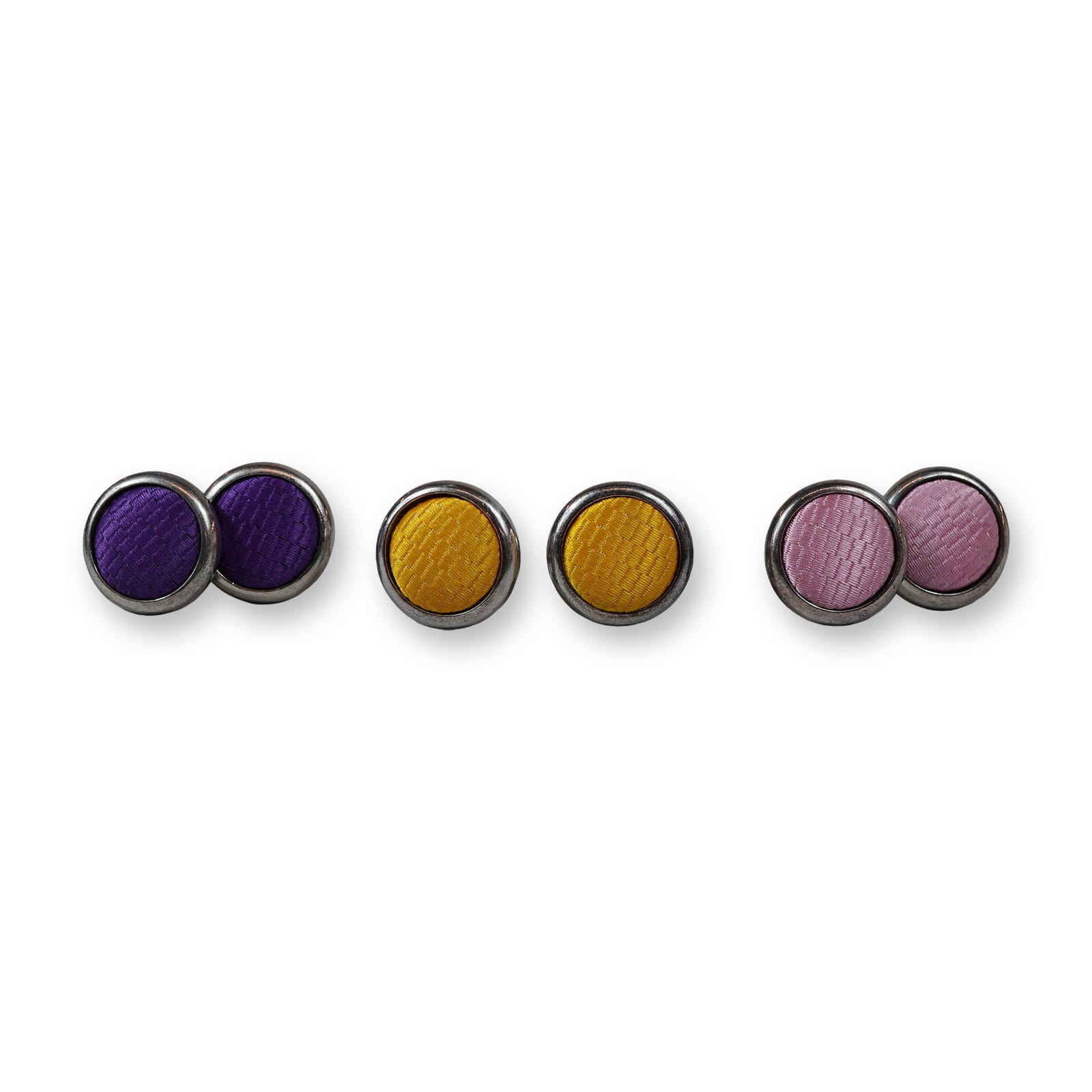 6pc Thomas Pink Fabric-Inlaid Cufflinks: This group includes three pairs of cufflinks by Thomas Pink, each crafted in silver-toned metal with circular fabric inlays featuring a textured diagonal weave. The set comprises one pair each in purp