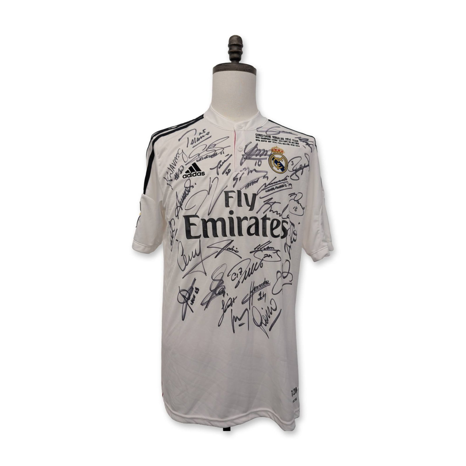 Real Madrid Cristiano Ronaldo Signed 2014-15 Home Soccer Jersey: Adidas brand 2014-15 Real Madrid CF home soccer jersey in white polyester with black stripes and pink accents. The front chest features printed text commemorating Cristiano Ronaldos 2014 season achiev