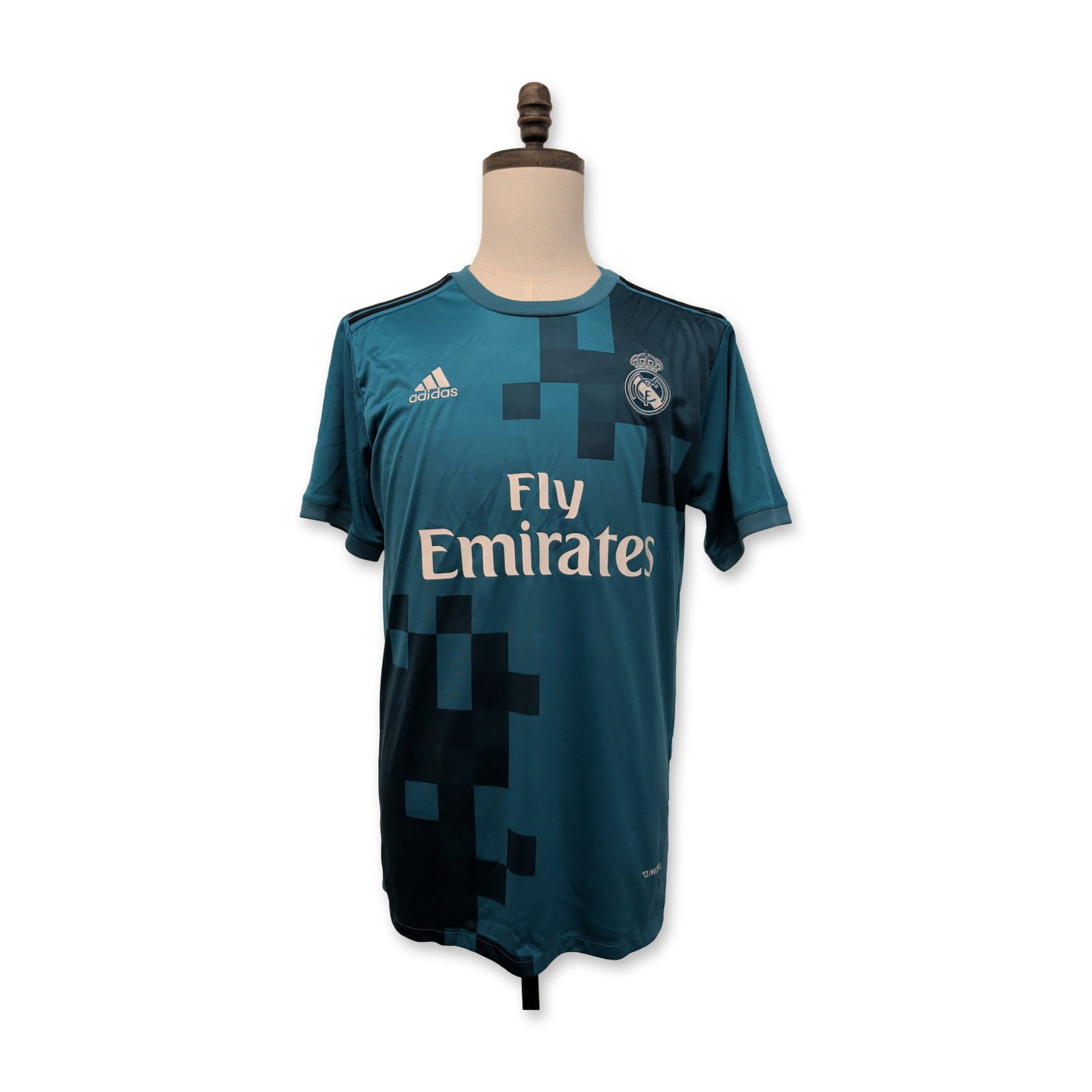 Signed Cristiano Ronaldo Real Madrid Third Soccer Jersey: Adidas Real Madrid C.F. third jersey from the 2017-2018 season in teal polyester, featuring a dark blue pixelated graphic pattern on the upper and lower front. The jersey displays the Real Madrid club