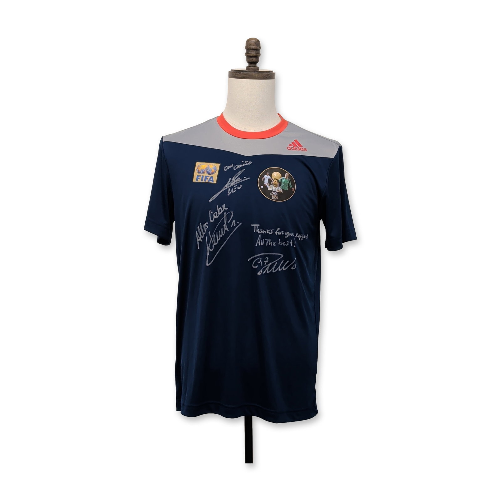 Signed Adidas 2014 FIFA Ballon d'Or Commemorative Soccer Jersey: Signed Adidas commemorative soccer jersey for the 2014 FIFA Ballon d'Or finalists. The navy blue climalite fabric shirt features silver shoulder panels, a red crew neck collar, and a central circular 