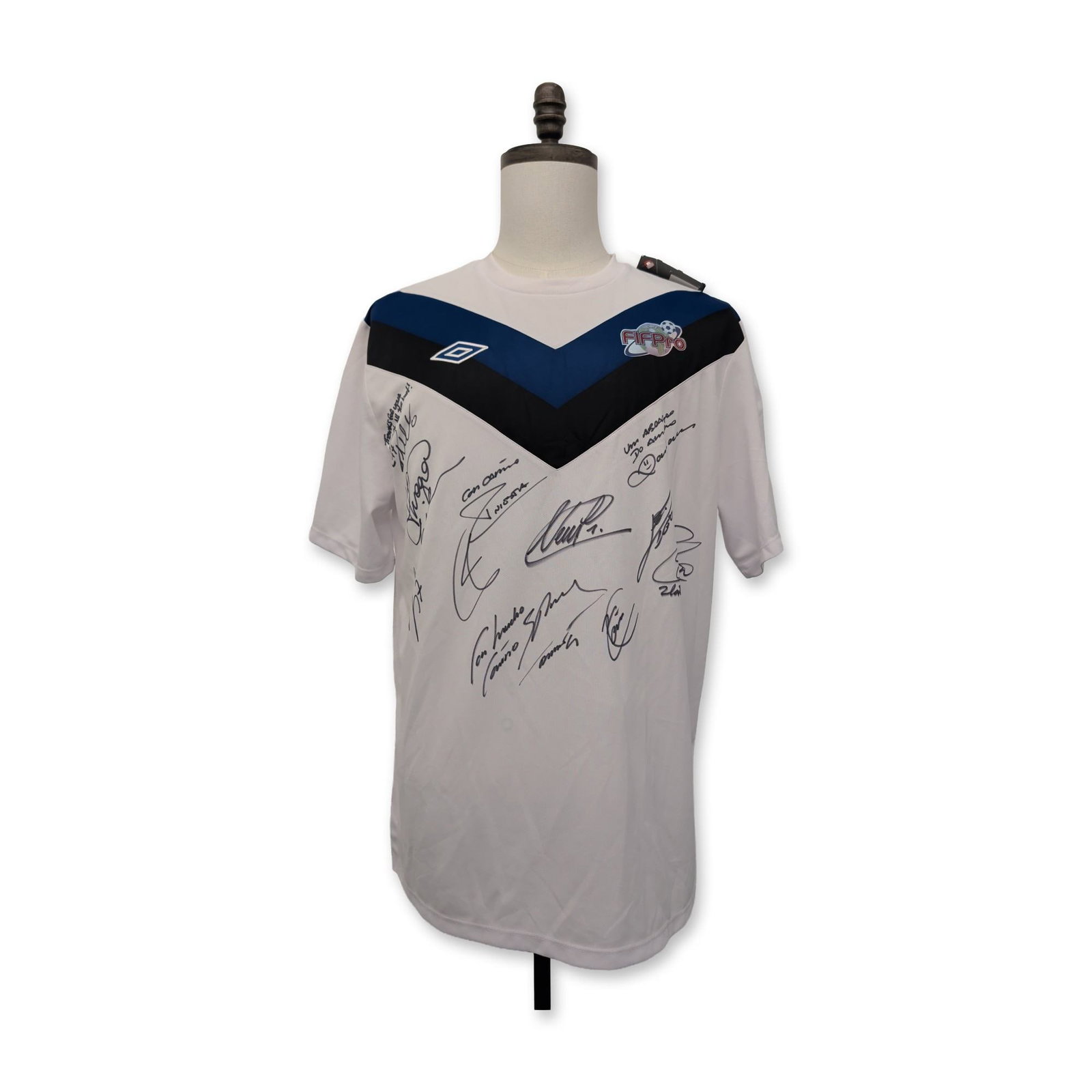 Umbro 2013 FIFPro World XI Signed Soccer Jersey: Umbro limited edition commemorative soccer jersey for the 2013 FIFPro World Team of the Year. The white short-sleeved garment features a V-neck and a distinctive blue and black chevron panel on the ri