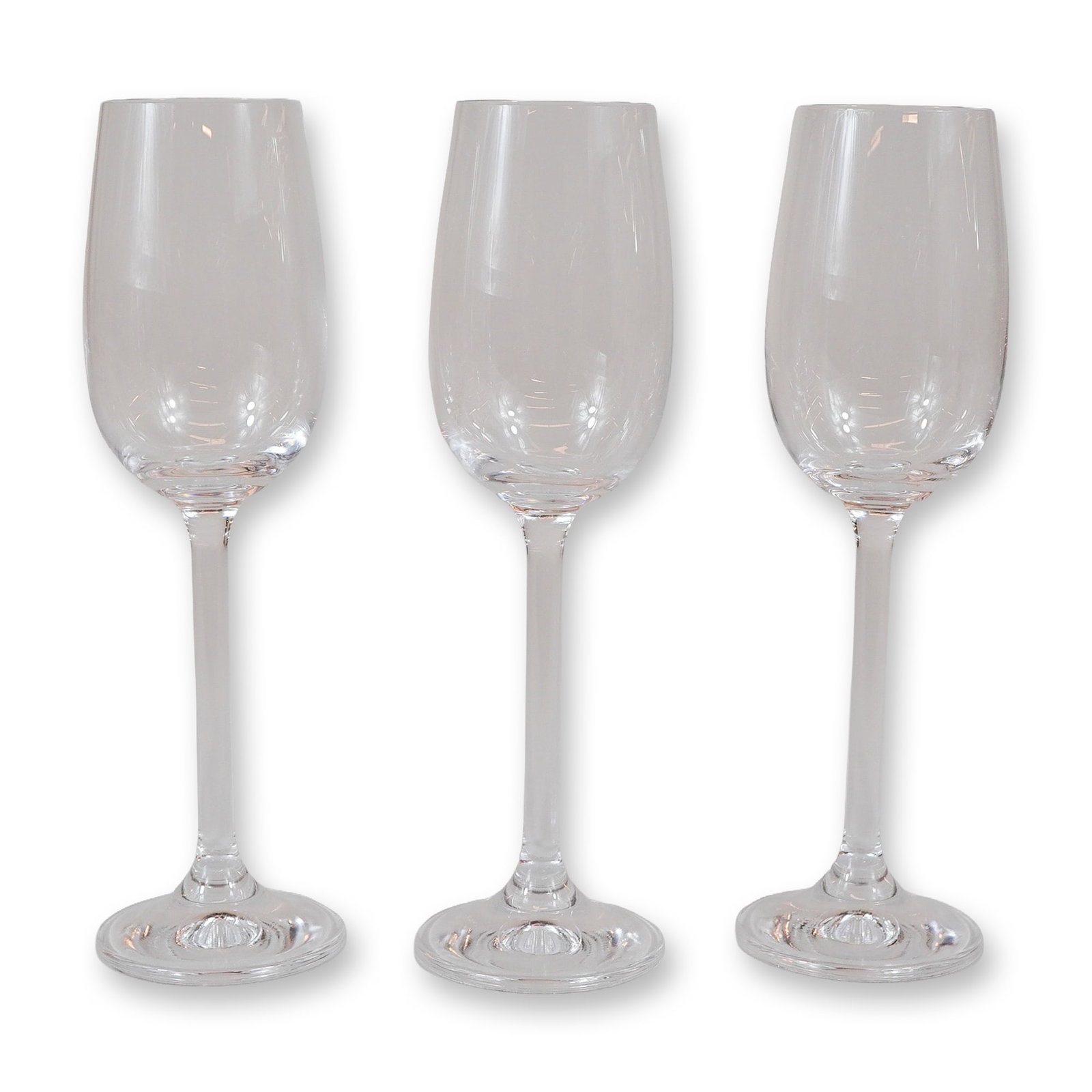 3pc Contemporary Clear Glass Champagne Flutes: A set of three matching contemporary clear glass stemware pieces, designed as champagne flutes. Each piece features a tall, narrow tulip-form bowl that tapers slightly toward the rim, supported by a l