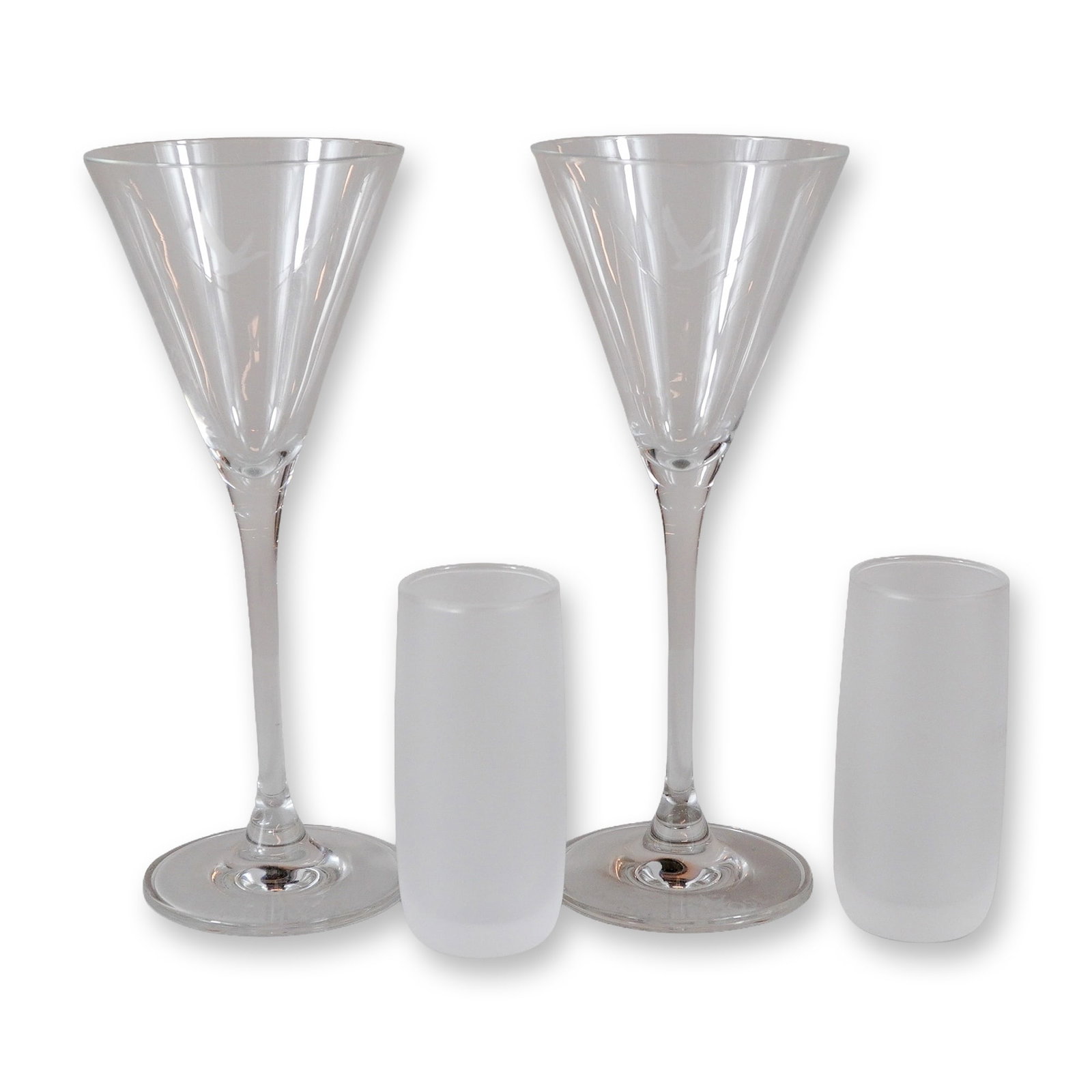 Set of Four Branded Grey Goose and Remy Martin Promotional Spirit Glasses: The martini glasses are constructed from clear, colorless glass and feature a tall, slender stem supporting a conical bowl. Each bowl is embellished with an etched image of a goose in flight. The