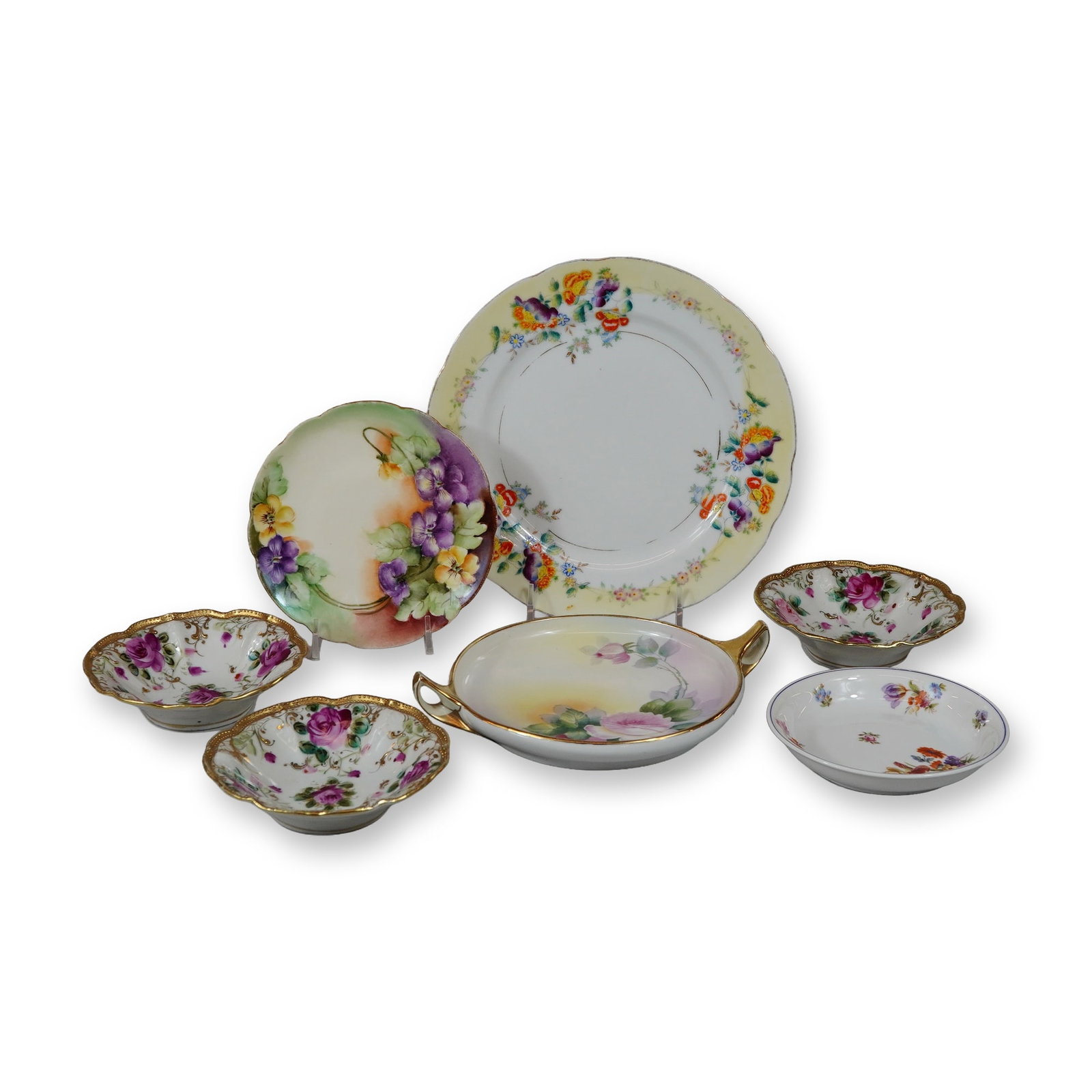 7pc Porcelain Plate and Dish Grouping: This 7pc porcelain plate and dish grouping consists of various tableware items produced primarily in Germany and Japan during the mid-20th century. The collection is crafted from fine white porcelain 