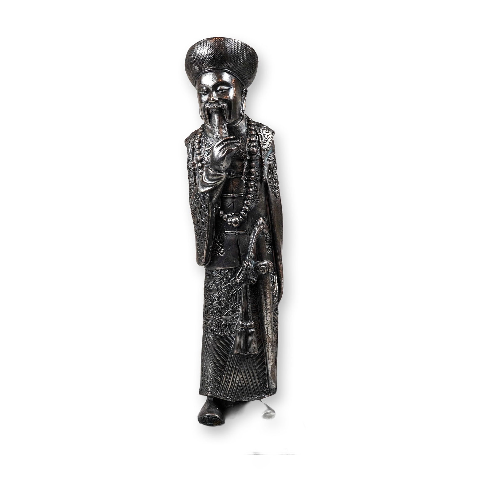 Sterling Silver Figurine of a Chinese Official: A sterling silver figurine depicting a Chinese official in traditional Qing dynasty court dress. The figure is shown standing, wearing a round court hat and a long beaded court necklace known as a cha