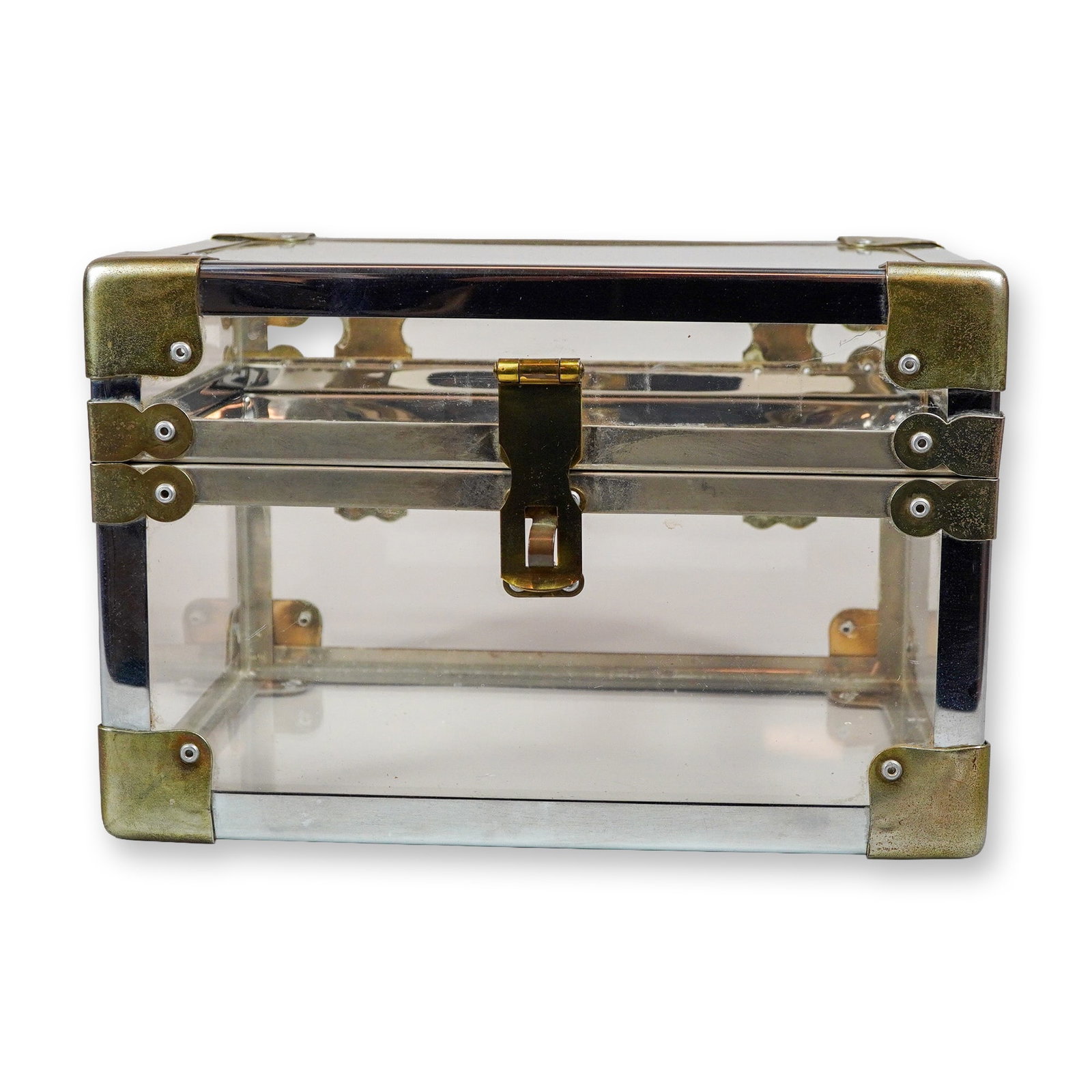Lucite and Brass Tabletop Trunk with Silver-Toned Edge Pieces: This tabletop trunk or jewelry box is constructed with clear Lucite panels set into a polished silver-toned metal frame. Designed in the Hollywood Regency style of the late 20th century, the box featu