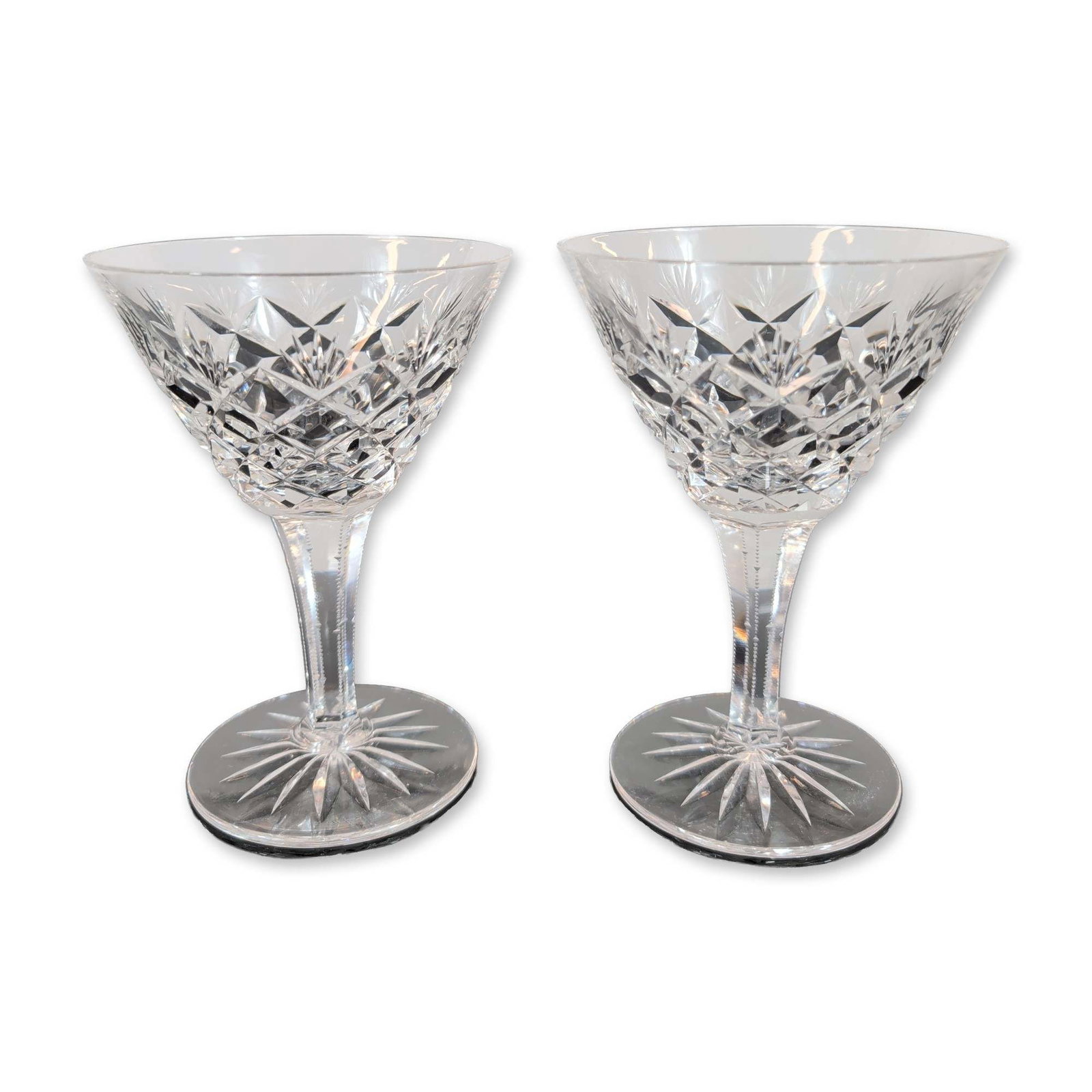 Pair of Cut Crystal Stemware Glasses: Pair of cut crystal stemware glasses, featuring a conical flared bowl decorated with a lower band of cross-hatched diamond cuts beneath a band of fan cuts. The hexagonal faceted stem is adorned with