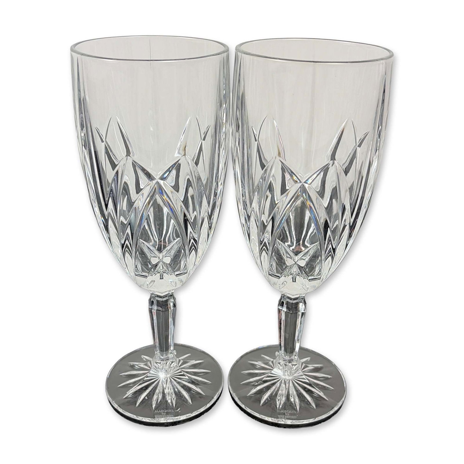Pair of Marquis by Waterford Crystal Brookside Iced Tea Glasses: Each bowl features a lower register of deep-cut crisscross diamond motifs beneath upright wedge cuts. The design includes a multi-faceted stem and a circular foot with an underside starburst cut.