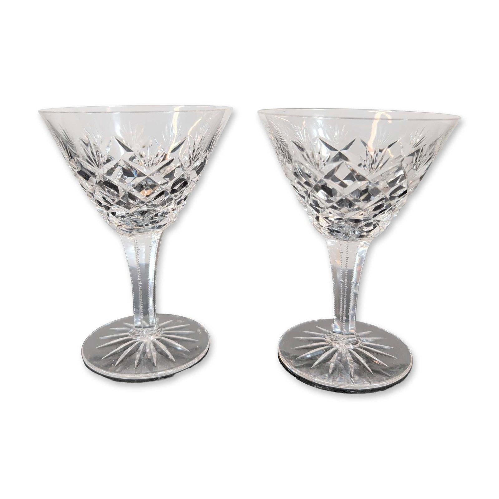 Pair of Waterford Cut Crystal Wine Glasses: Pair of cut crystal wine glasses. Each glass features a flared bowl decorated with a lower band of deep diamond cuts below polished vertical cuts, a faceted stem with zippered notch cuts along the