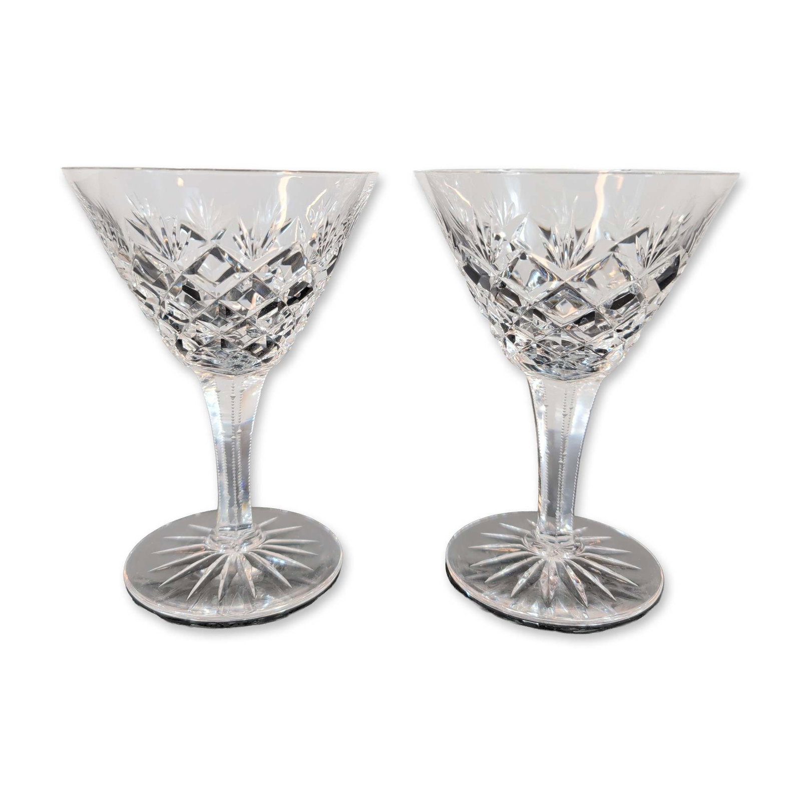 2pc Lead Crystal Stemmed Glasses: Pair of stemmed glasses in cut lead crystal, featuring conical bowls with a band of diamond-cut cross-hatching below a series of fanned starburst cuts. The faceted stems include vertical zipper