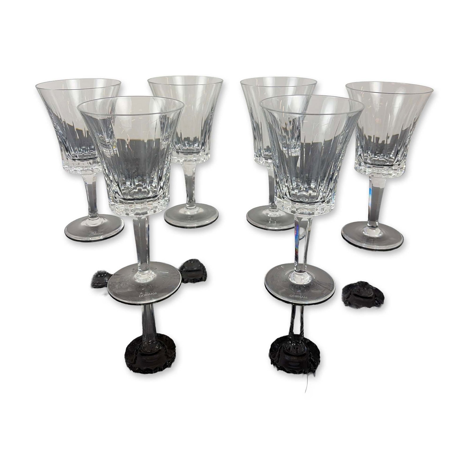 Set of Six Gorham Richelieu-Rondo Crystal Wine Glasses: Each glass features vertical wedge cuts on the upper portion of the bowl transitioning into a deeply faceted, paneled base. The faceted, multisided stems lead to a plain circular foot. Each piece is m