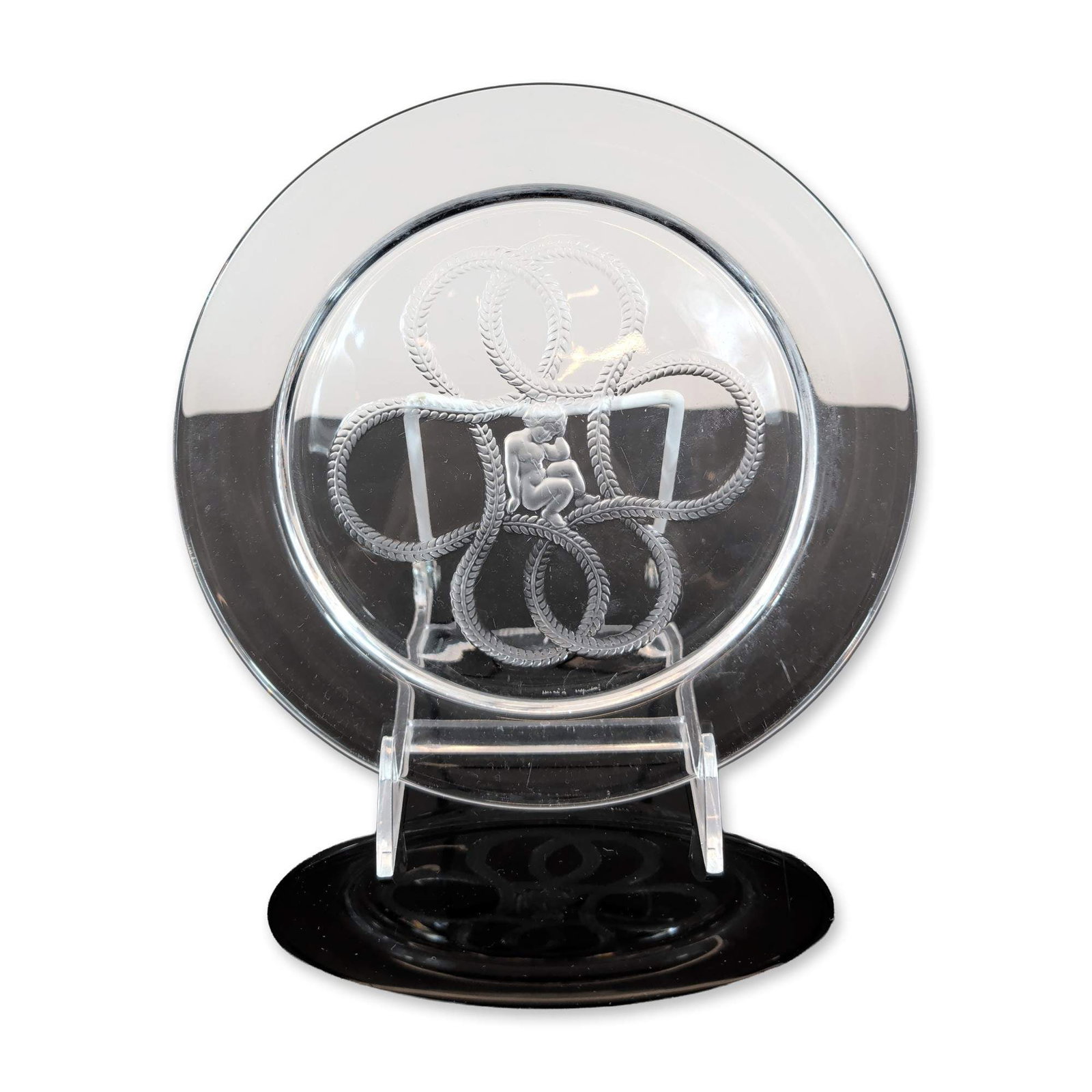 Lalique France Olympe Crystal Salad Plate: Lalique, France. Olympe pattern salad plate in clear and frosted crystal, featuring a central frosted relief medallion of a crouching nymph or cherub figure. The central motif is surrounded by four in