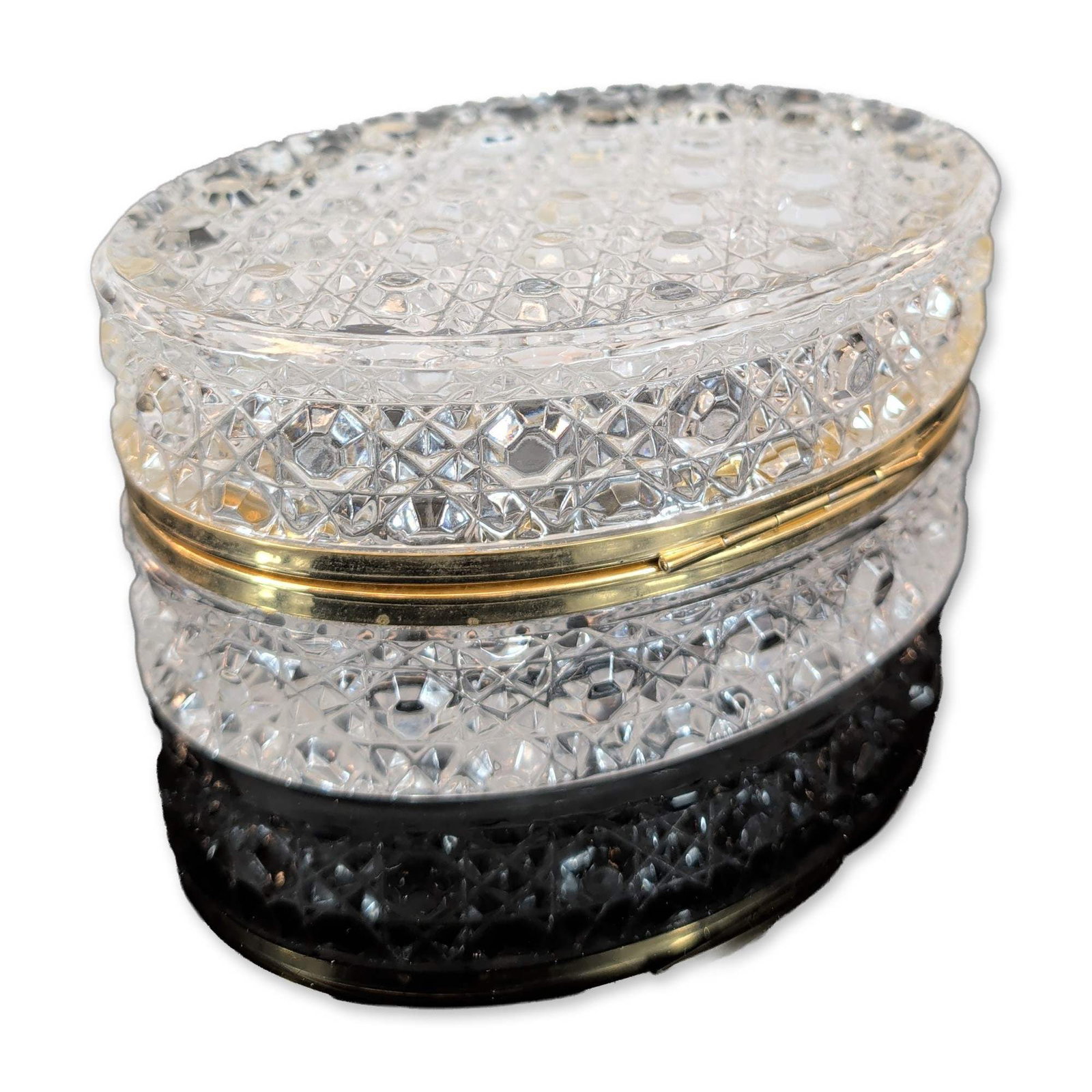 Baccarat Style Cut Crystal Jewelry Box: Baccarat style. Round jewelry casket in cut lead crystal with gold-toned metal mounts. The lid features a central pinwheel pattern with six miter-cut blades radiating from a starburst, surrounded by f