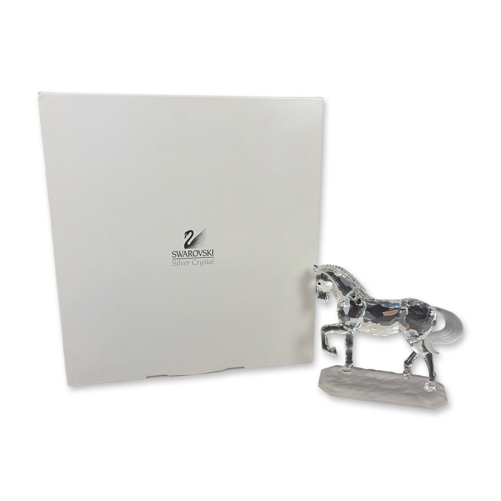 Swarovski Silver Crystal Arabian Stallion Figurine: Swarovski lead crystal figurine of an Arabian Stallion in a prancing pose, featuring a faceted clear crystal body, frosted crystal mane and tail, and black crystal eyes. Mounted on an irregular, textu