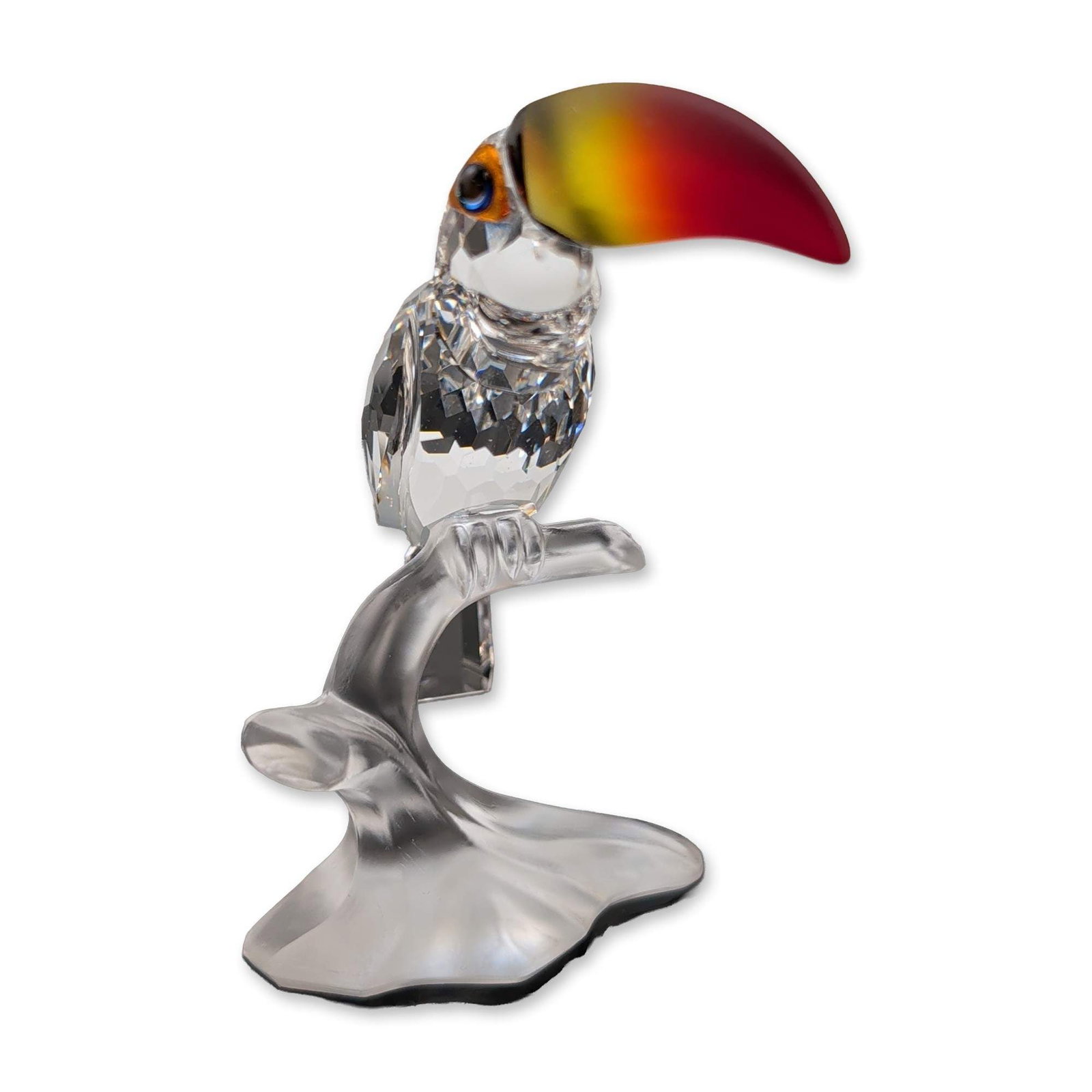 Swarovski Silver Crystal Figurine, Toucan by Michael Stamey: Swarovski Silver Crystal figurine of a toucan on a branch, designed by Michael Stamey as part of the Feathered Beauties collection. The piece features a multi-faceted clear crystal body with a rectang
