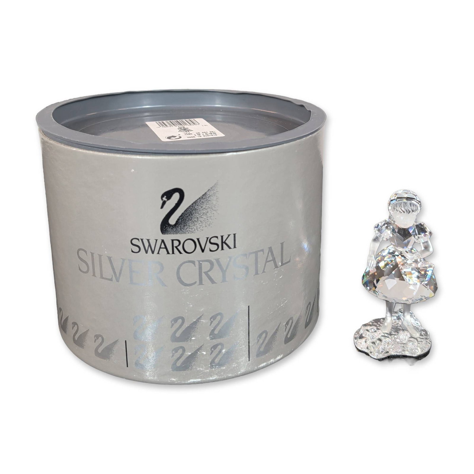 Swarovski Silver Crystal Little Red Riding Hood Figurine: Swarovski Silver Crystal Little Red Riding Hood constructed of lead crystal featuring a faceted skirt, frosted crystal head and arms, and a small flower basket. The figurine is mounted on a textured c