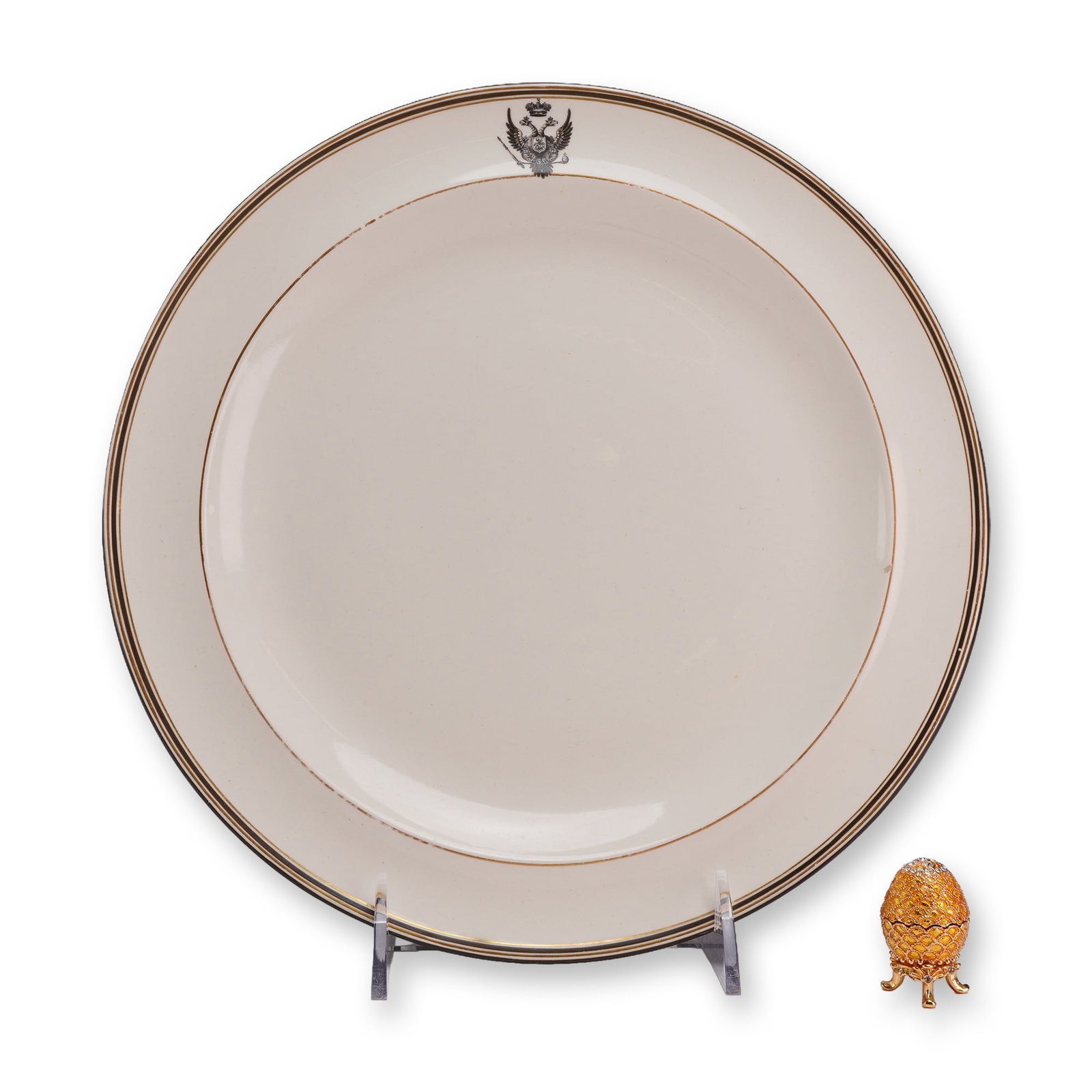 2pc Wedgwood Creamware Russian Imperial Armorial Plate and an AKM Faberge-Style Trinket Box: A fine creamware service plate manufactured by Wedgwood. The plate features a cream-colored earthenware body decorated with concentric bands of gilding and dark enamel. Centered at the top of the rim 