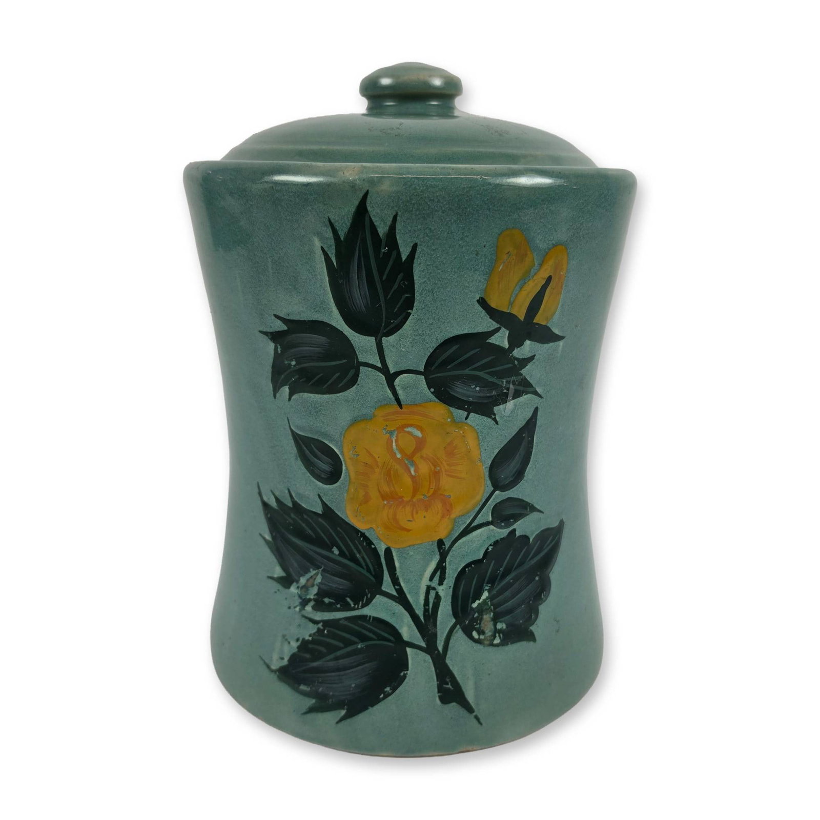 McCoy Concave Ceramic Floral Canister: The vessel features a concave, slightly waisted cylindrical form with a matching domed lid topped by a button-style knob finial. Finished in a semi-matte teal green glaze, the front is decorated with 