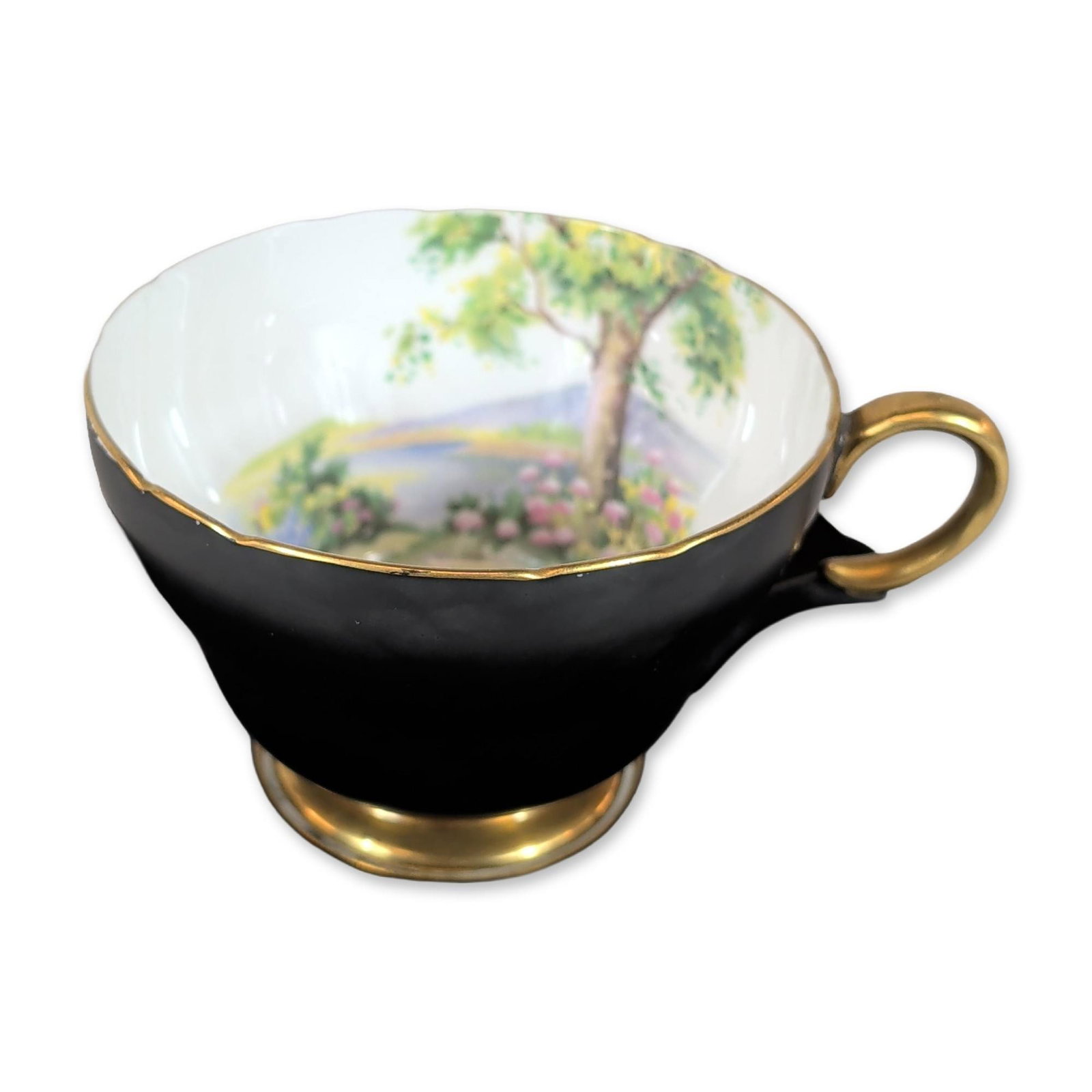 Shelley Bone China Woodland Pattern Cup and Saucer: Shelley Potteries, Staffordshire, England. Teacup and saucer set in fine bone china, featuring the Woodland pattern (number 13443/24) in the Richmond shape. The pieces feature a matte ebony black exte