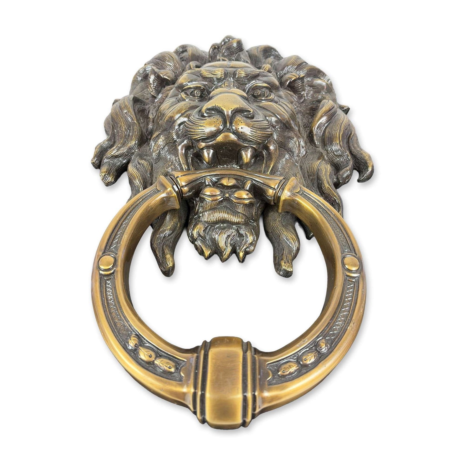 Classical Style Cast Brass Lion Head Door Knocker: Classical style large door knocker in cast brass. The design features a detailed lion mask with a scrolling mane holding a circular ring. The ring is decorated with a stippled geometric border and