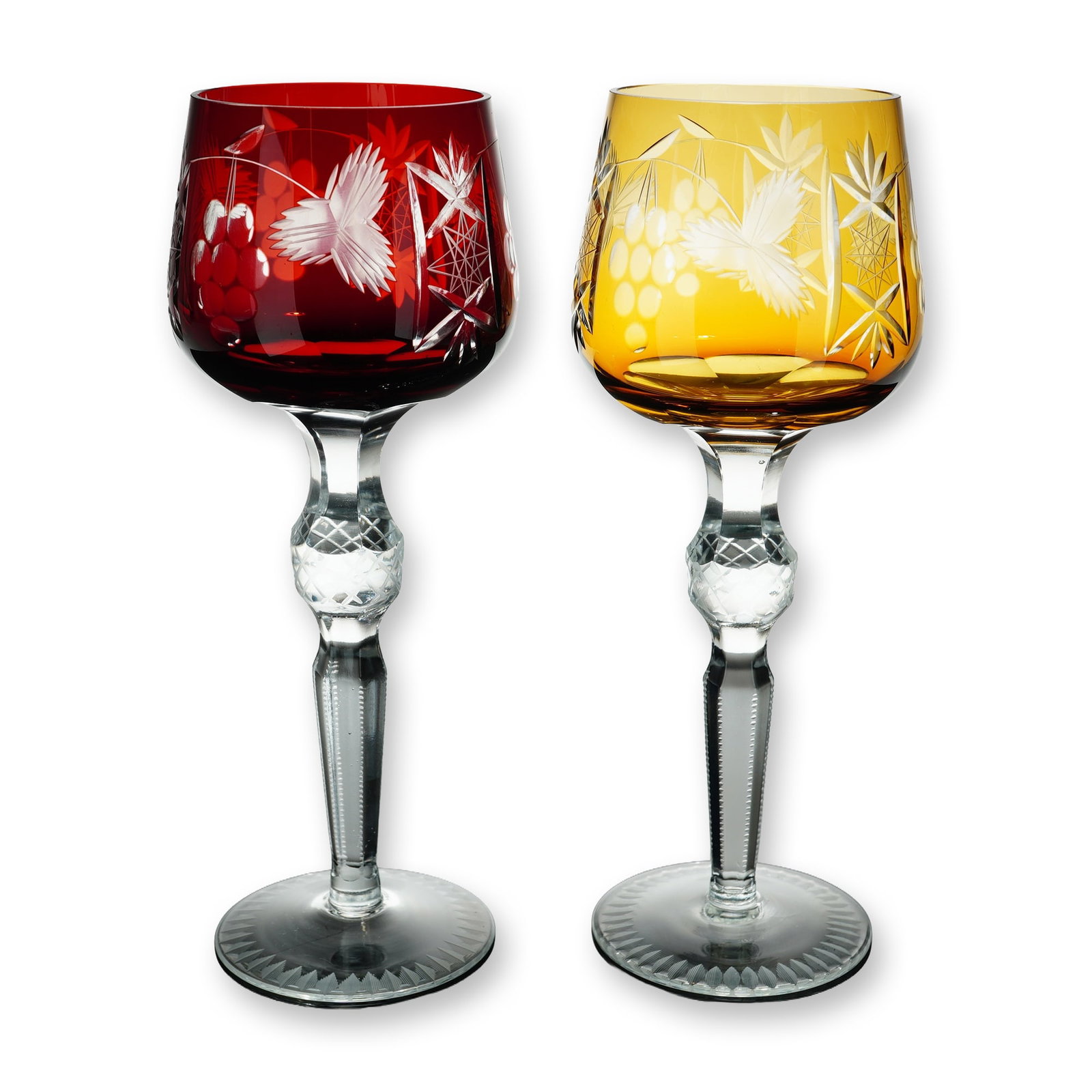 2pc Bohemian Style Cut to Clear Crystal Hock Glasses: Continental European, possibly German or Bohemian. Pair of hock wine glasses in lead crystal, featuring one glass cased in ruby red and one in amber yellow. Each vessel is cut to clear with a traditio