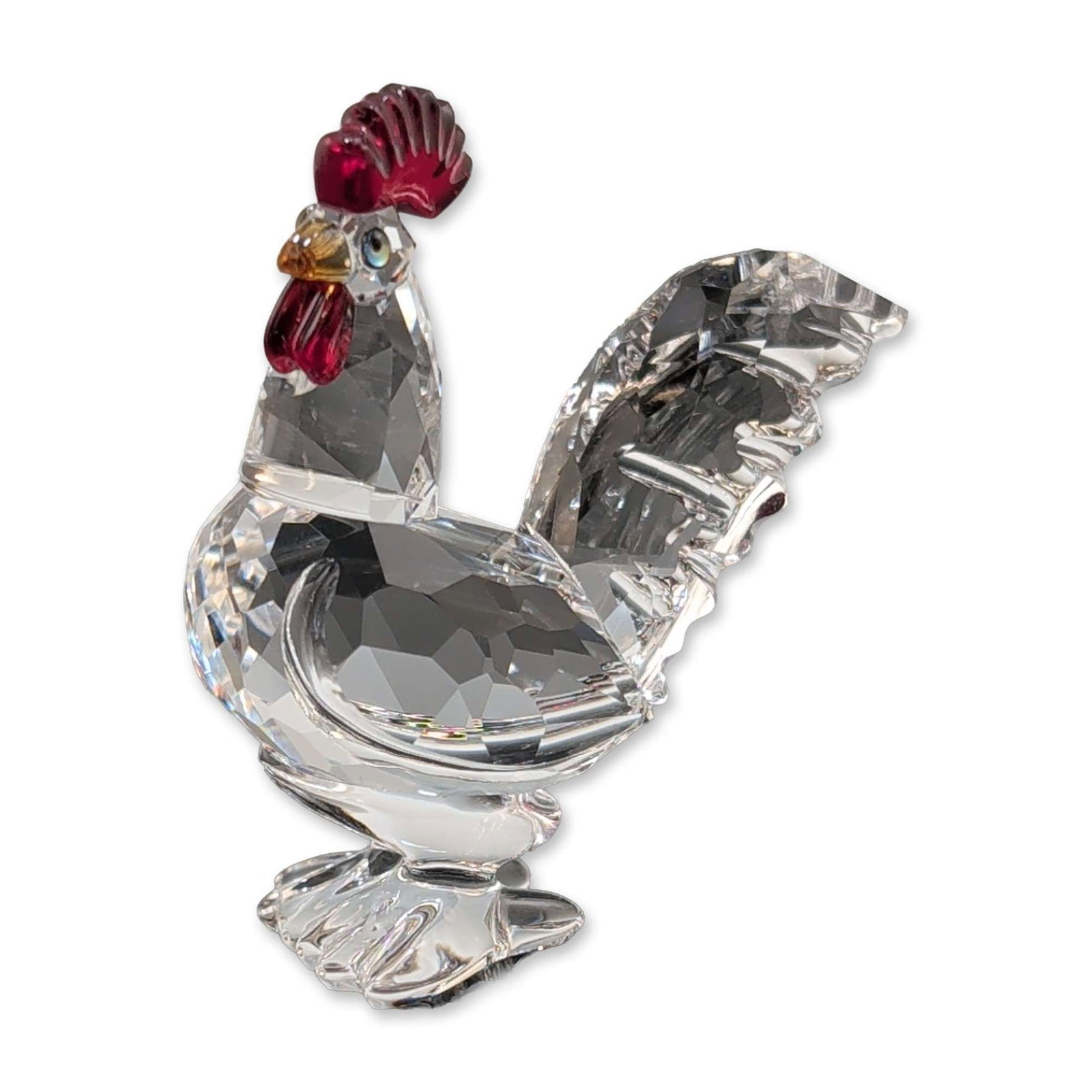 Swarovski Crystal Cockerel Figurine: Swarovski Cockerel figurine in faceted lead crystal, featuring a clear crystal body and tail with red crystal comb and wattle. The piece is accented with a yellow crystal beak and small inset eyes. Et