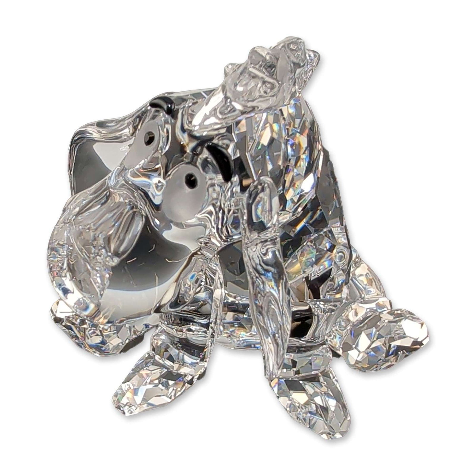 Swarovski Crystal Eeyore Figurine: Swarovski Eeyore figurine in faceted lead crystal, featuring black crystal eyes and nose, and a faceted collar detail. Etched Swarovski swan logo present on one facet. Includes original blue presentat