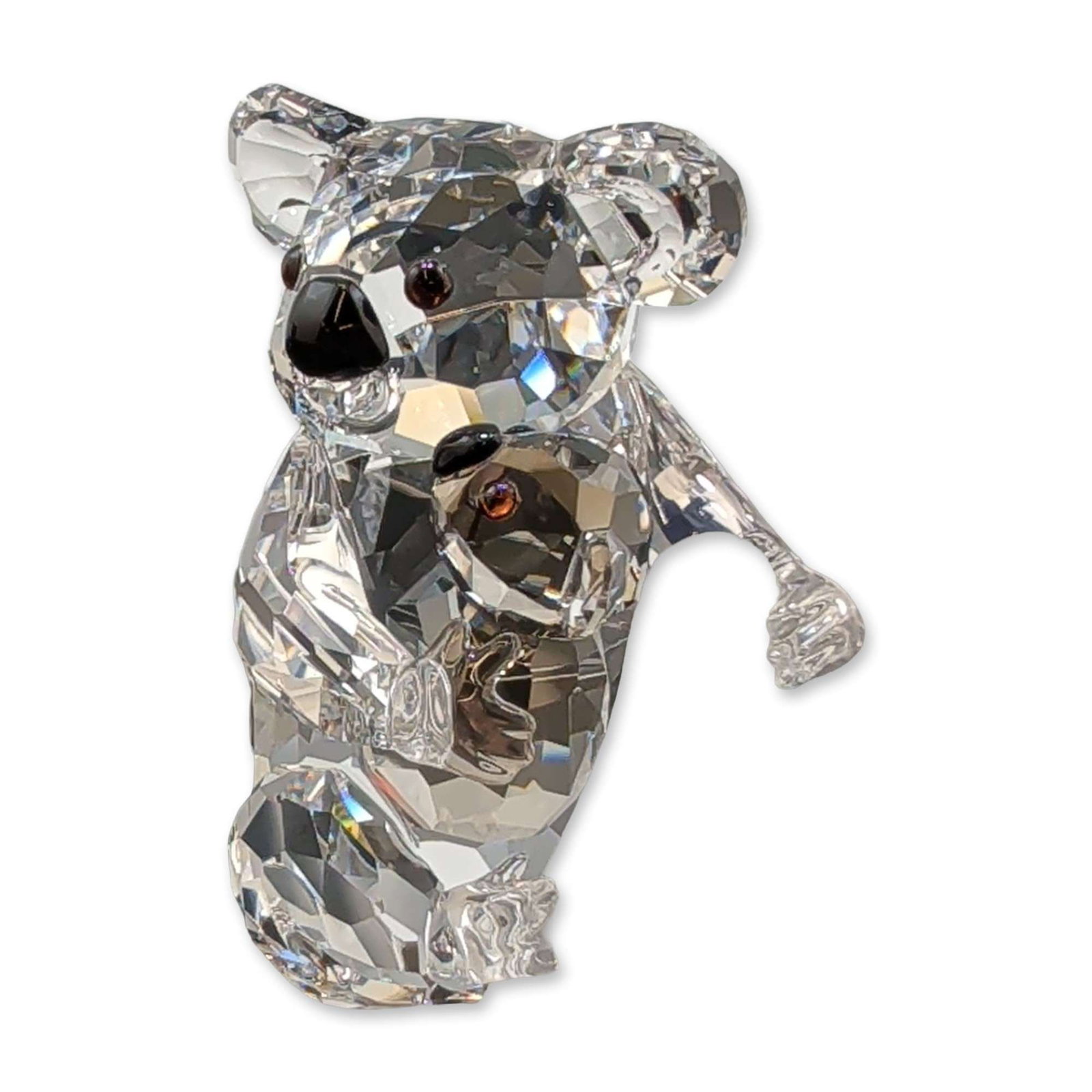 Swarovski Crystal Figurine, Koalas: Swarovski crystal figurine depicting a mother koala and joey climbing a branch. The koalas are rendered in faceted clear lead crystal with brown crystal eyes and black noses, set upon a frosted crysta