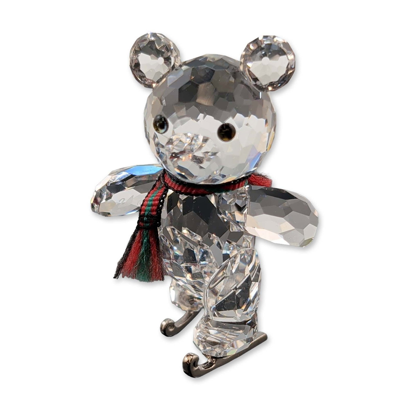 Swarovski Crystal Figurine, Kris Bear Skates: Swarovski crystal Kris Bear figurine. Faceted clear lead crystal teddy bear featuring jet black crystal eyes and nose. The figure is accented with a red and green striped fabric scarf and is mounted o