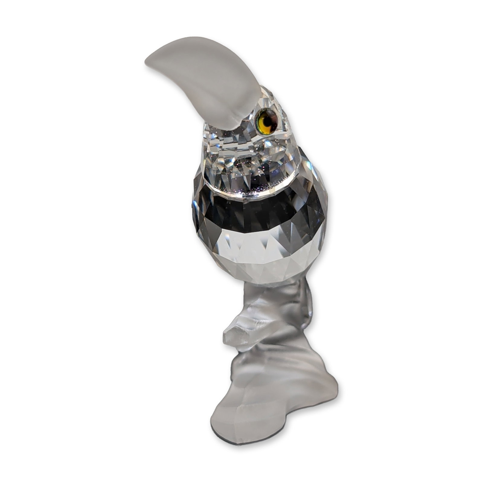 Swarovski Crystal Figurine, Toucan Signed by Michael Stamey: Swarovski lead crystal toucan figurine from the Silver Crystal collection. The piece is constructed with a multi-faceted clear crystal body and features a frosted crystal head, beak, and branch-style 