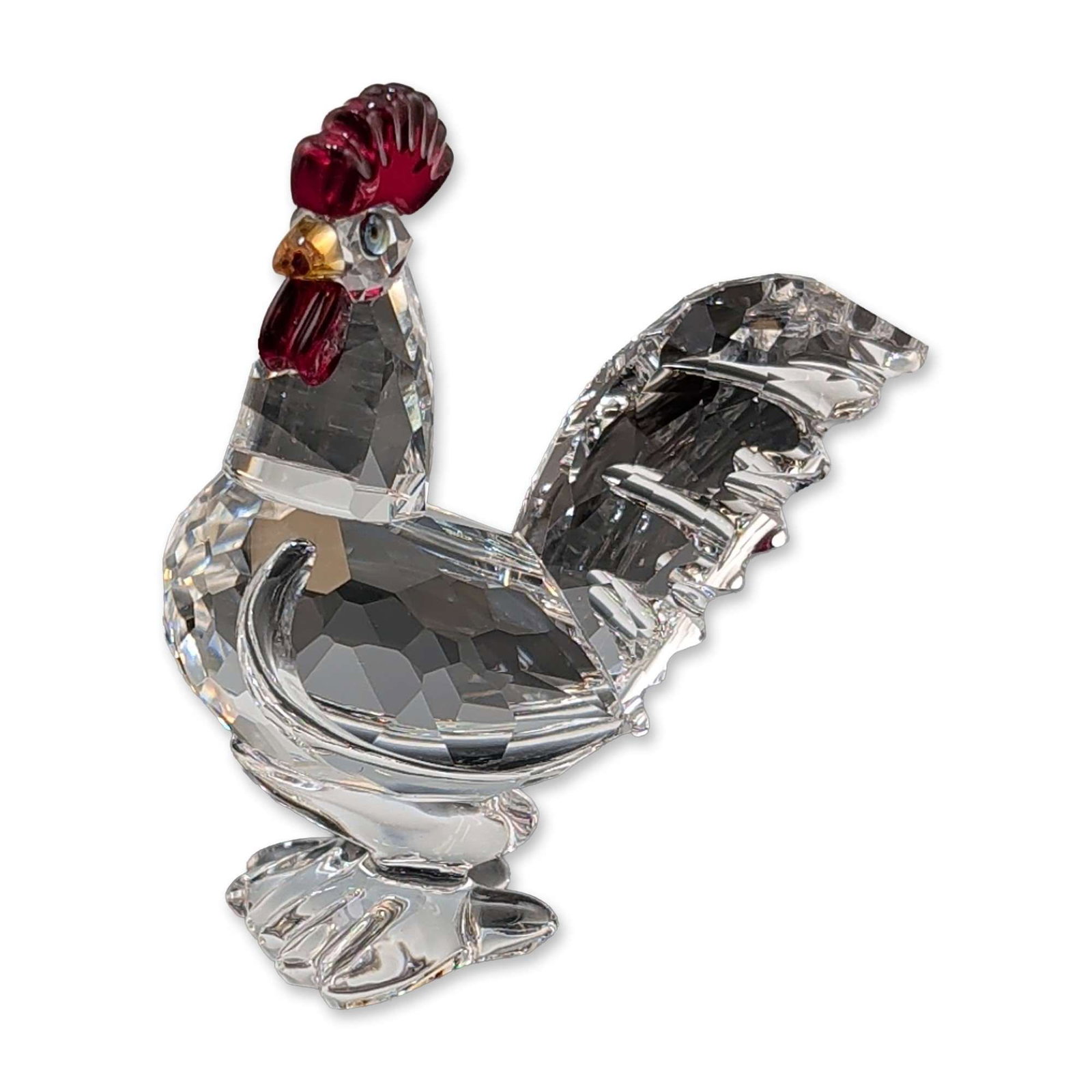 Swarovski Faceted Crystal Rooster Figurine: Swarovski faceted lead crystal rooster figurine. The clear faceted body and tail are accented by a deep red crystal comb and wattle, a yellow crystal beak, and small black eyes. The piece bears the et