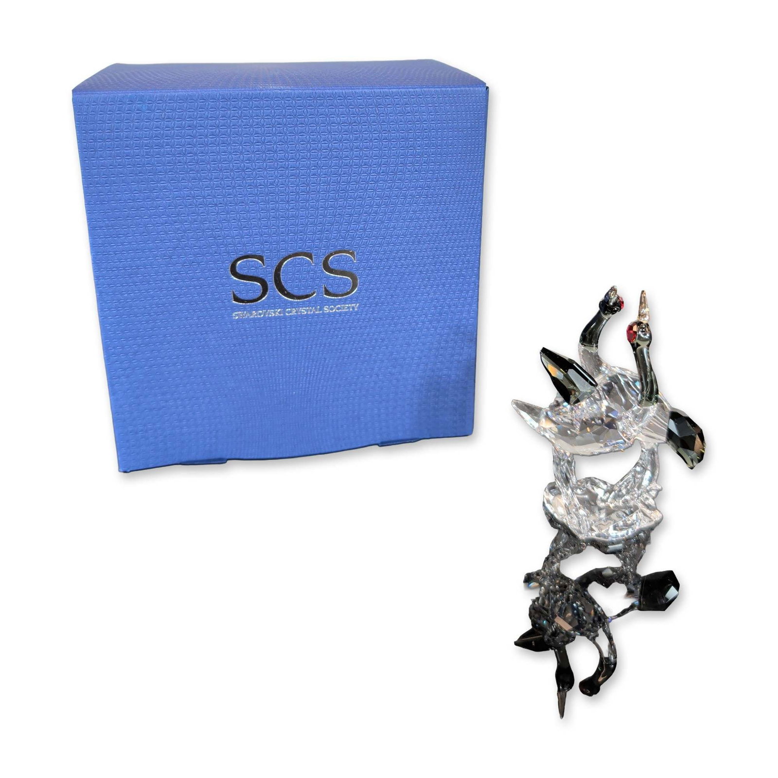 Swarovski SCS 2013 Crystal Red-Crowned Cranes Figurine: Swarovski Crystal Society (SCS) figurine featuring a pair of courting red-crowned cranes in faceted clear, black, and red crystal. The two birds are positioned in dynamic poses on a shared faceted cle