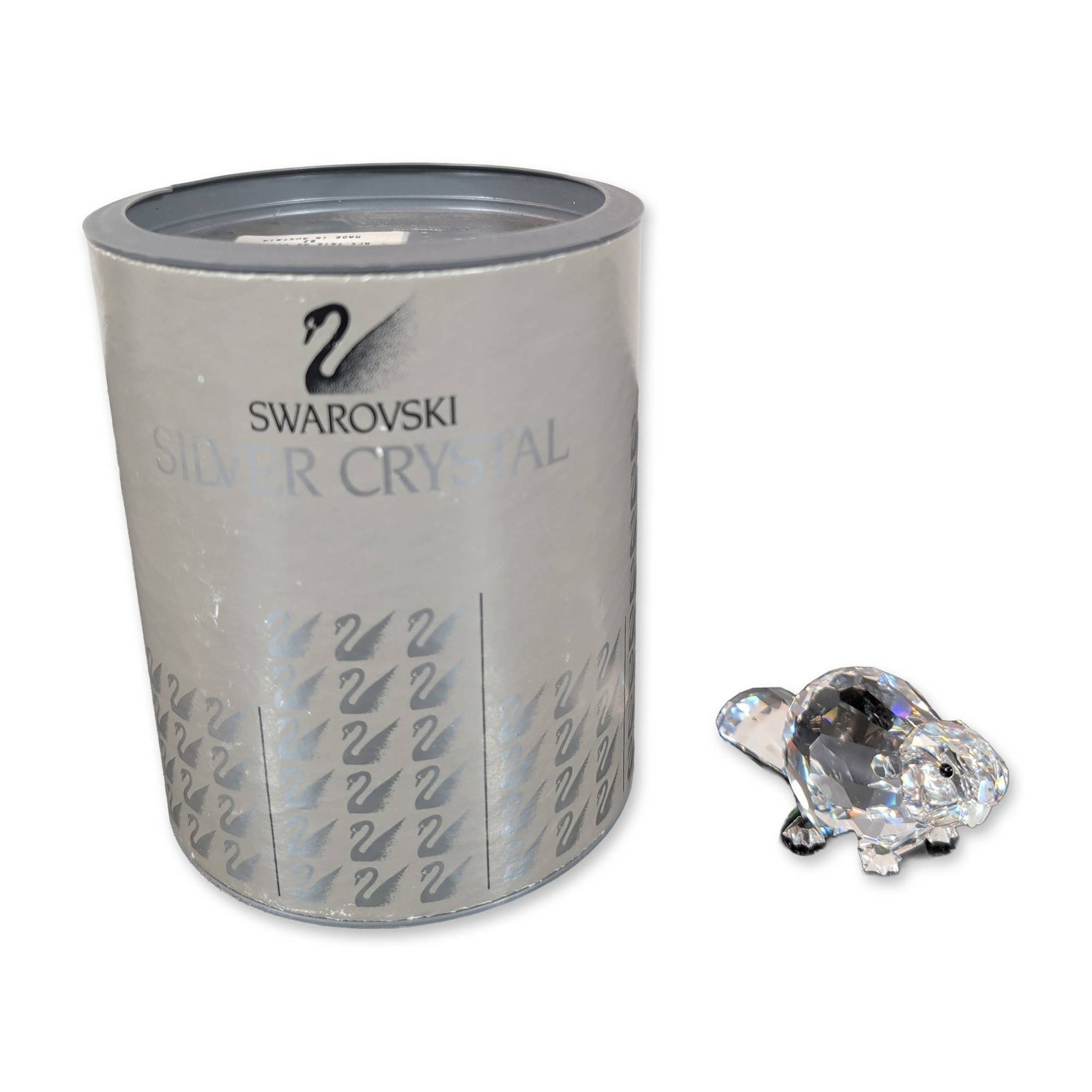 Swarovski Silver Crystal Mother Beaver Figurine: Swarovski Mother Beaver figurine crafted in faceted clear lead crystal that features a rounded body, small black inset eyes, and an upright faceted tail. An etched Swarovski swan logo is present on th