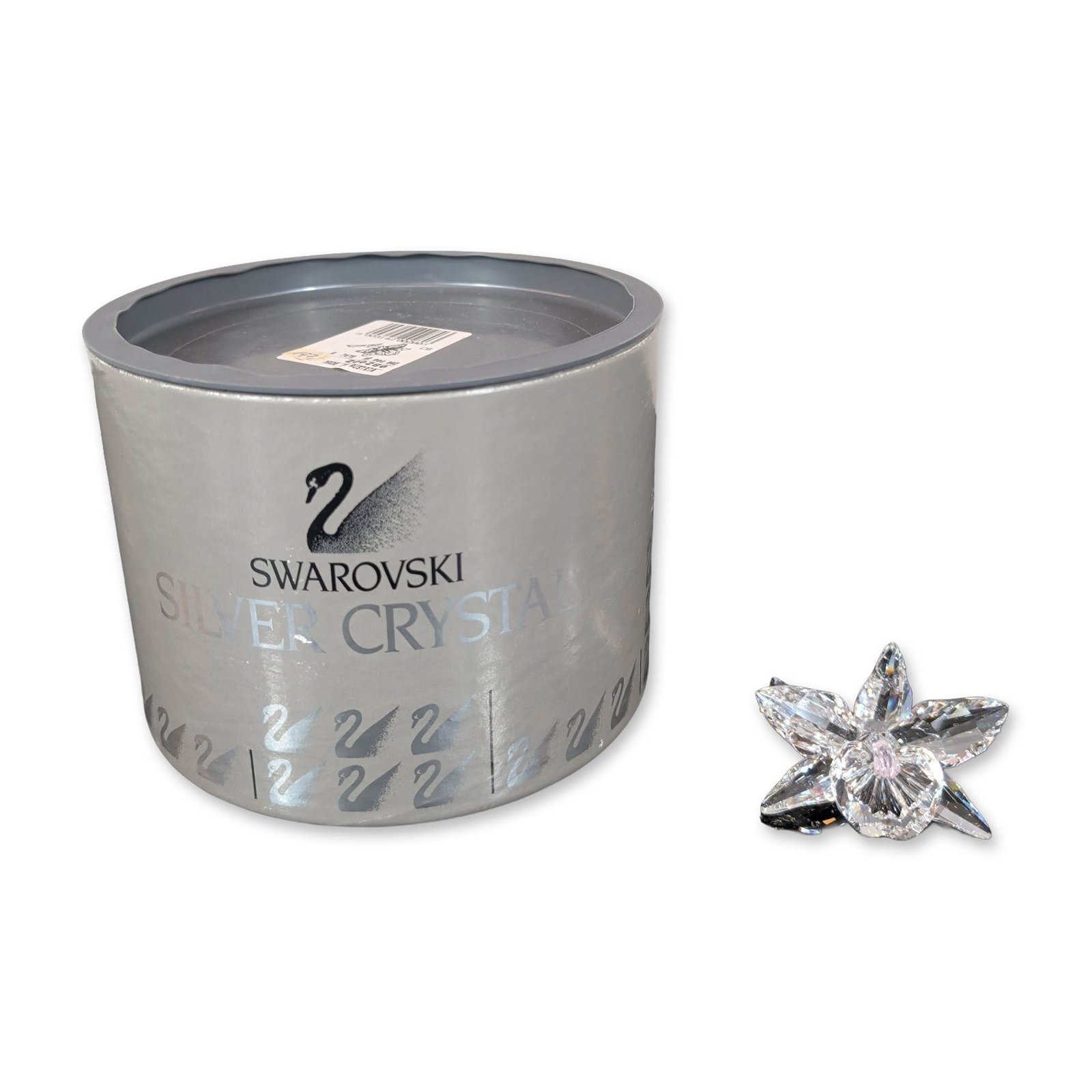 Swarovski Silver Crystal Orchid Figurine: Swarovski figurine depicting an orchid flower in faceted clear lead crystal. The piece features five radiating faceted petals surrounding a pale pink faceted center bud, mounted on a curved clear crys