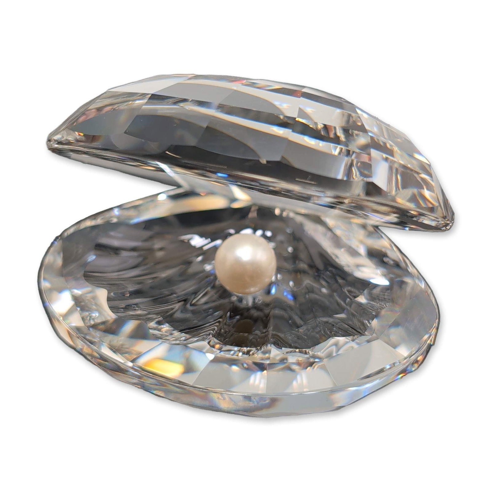 Swarovski Silver Crystal Oyster with Pearl: Swarovski Silver Crystal series faceted lead crystal figurine depicting an open oyster shell with a central cream-colored faux pearl. Base features the etched Swarovski swan trademark. Includes origin
