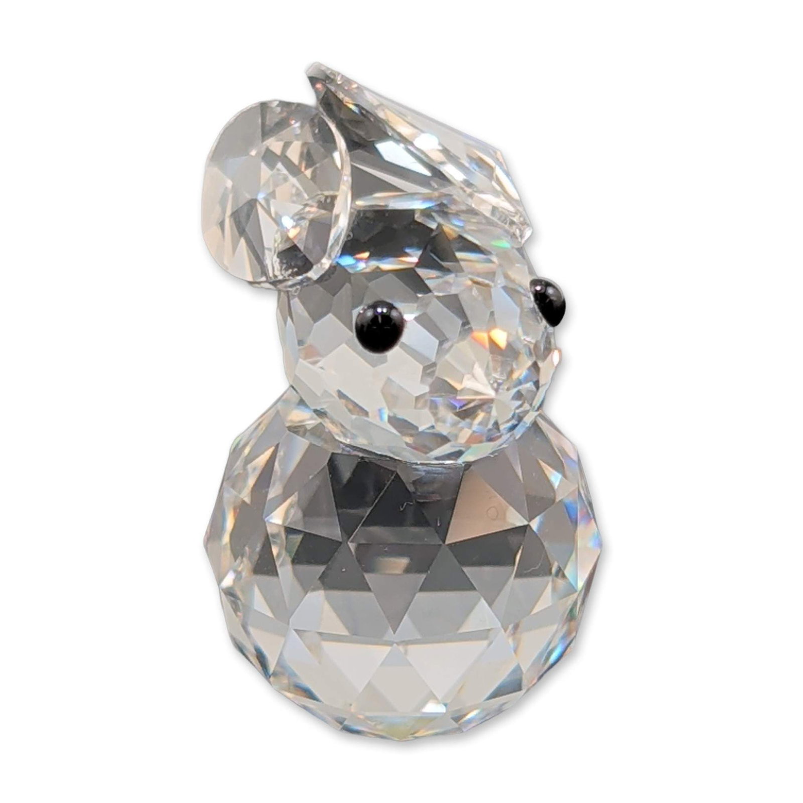 Swarovski Silver Crystal Rabbit Figurine: Swarovski rabbit figurine in faceted clear lead crystal, featuring two black bead eyes and a rounded tail. Etched swan mark on underside. Accompanied by original cylindrical storage box with Swarovski